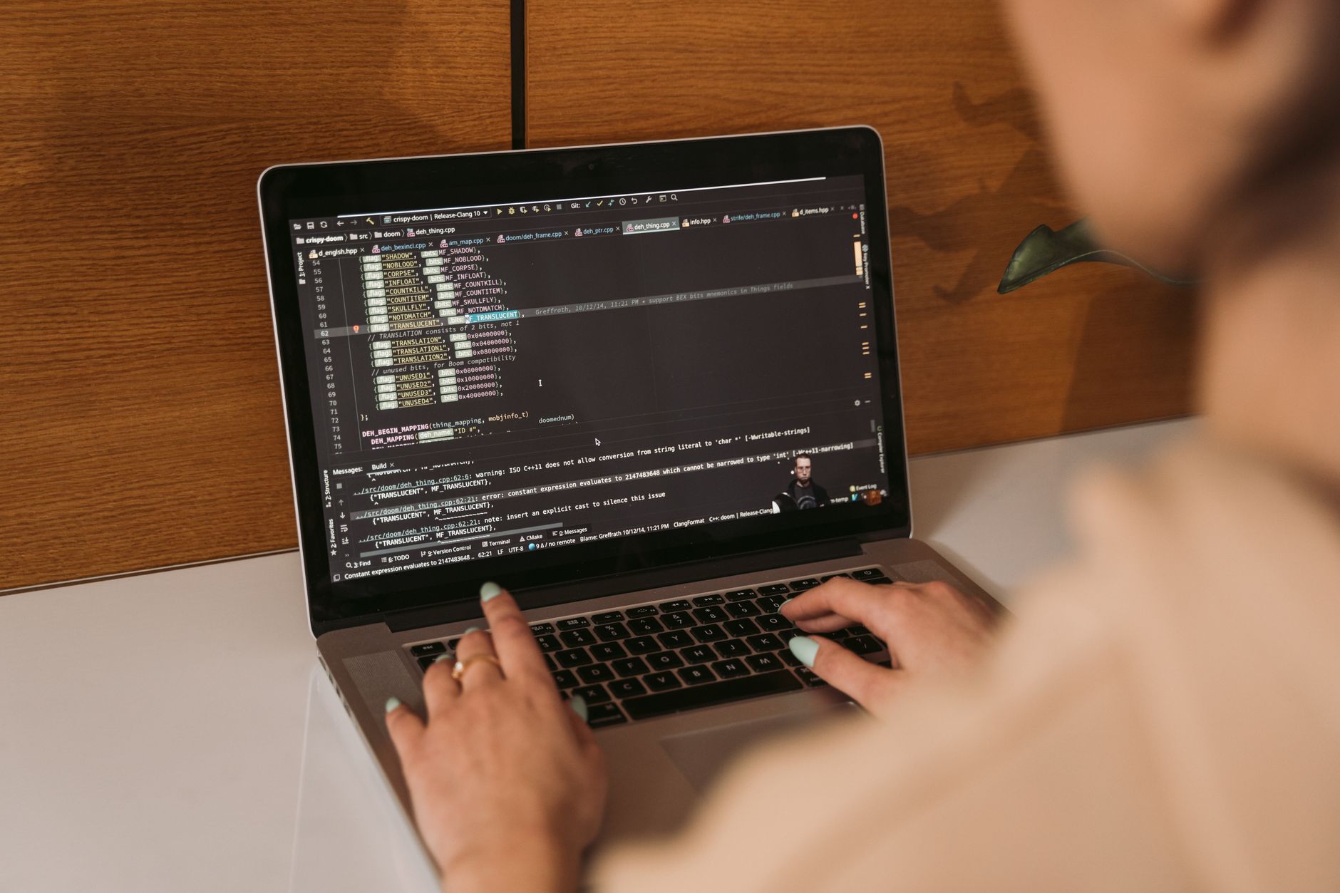 Data Science Using Python — Close-up of a woman coding using a laptop in an office environment, showcasing modern technology.