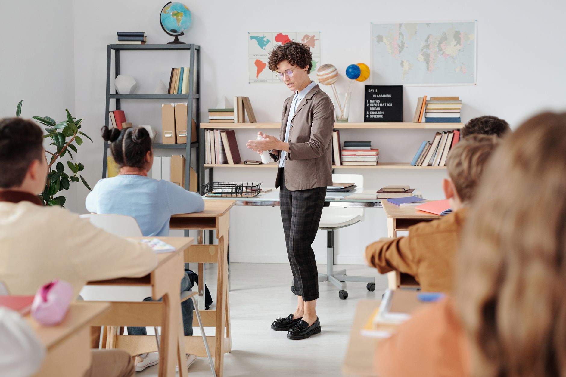 Principles of Teaching and Learning Theory and Practice — Teacher conducting a classroom lesson with attentive students in a vibrant educational setting.