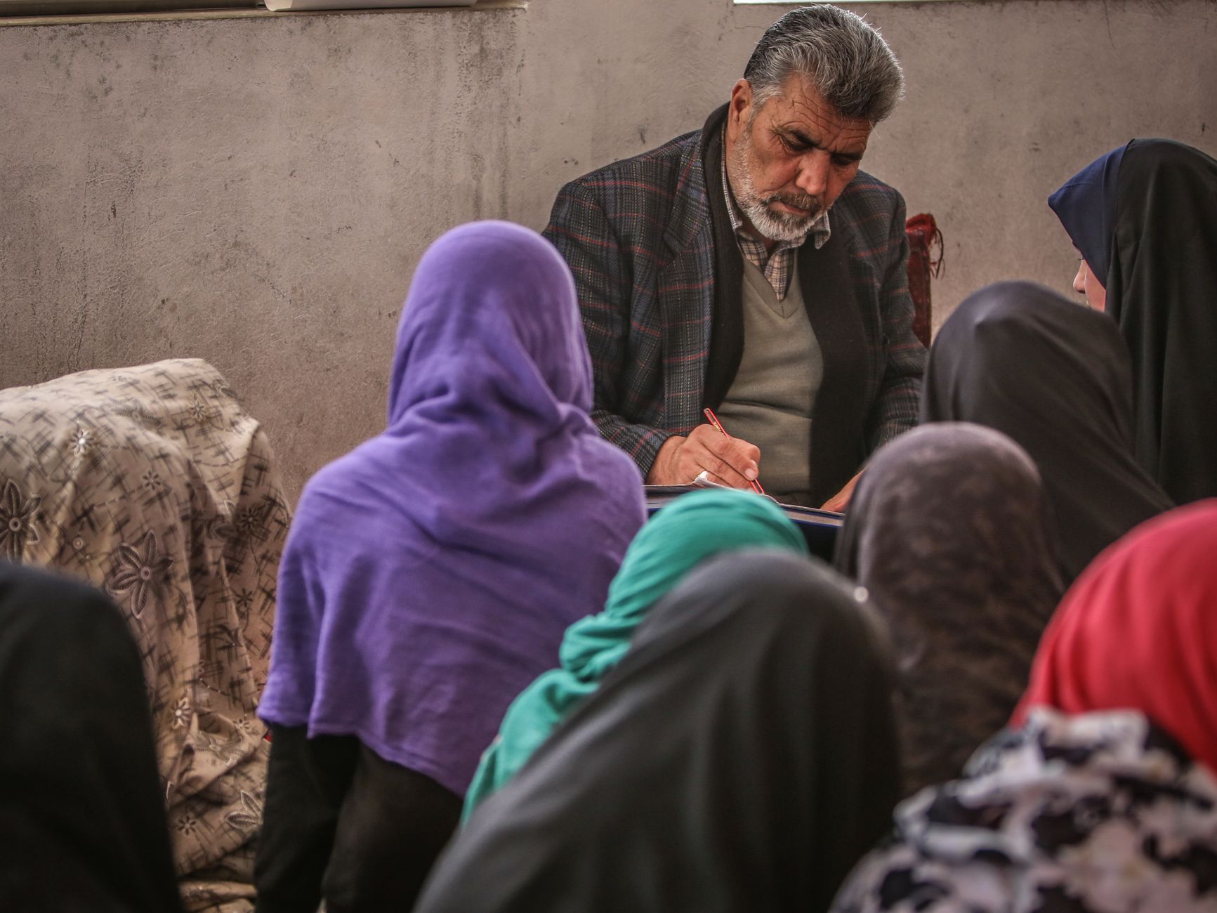 Arabic Language Pedagogy — An educational session featuring a teacher and students in a classroom setting, highlighting cultural learning practices.