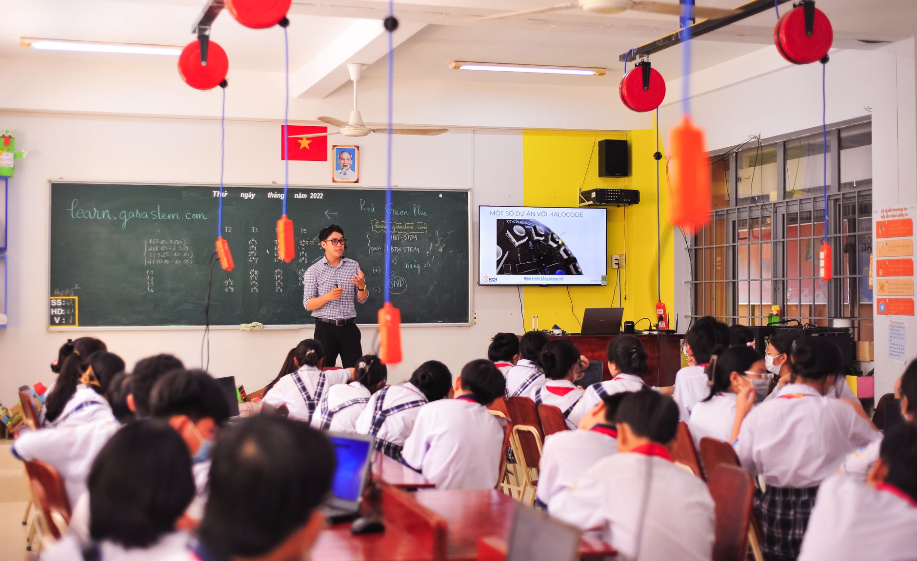 units – 35 credits: — Teacher conducts an interactive lesson in a vibrant classroom setting with attentive students.