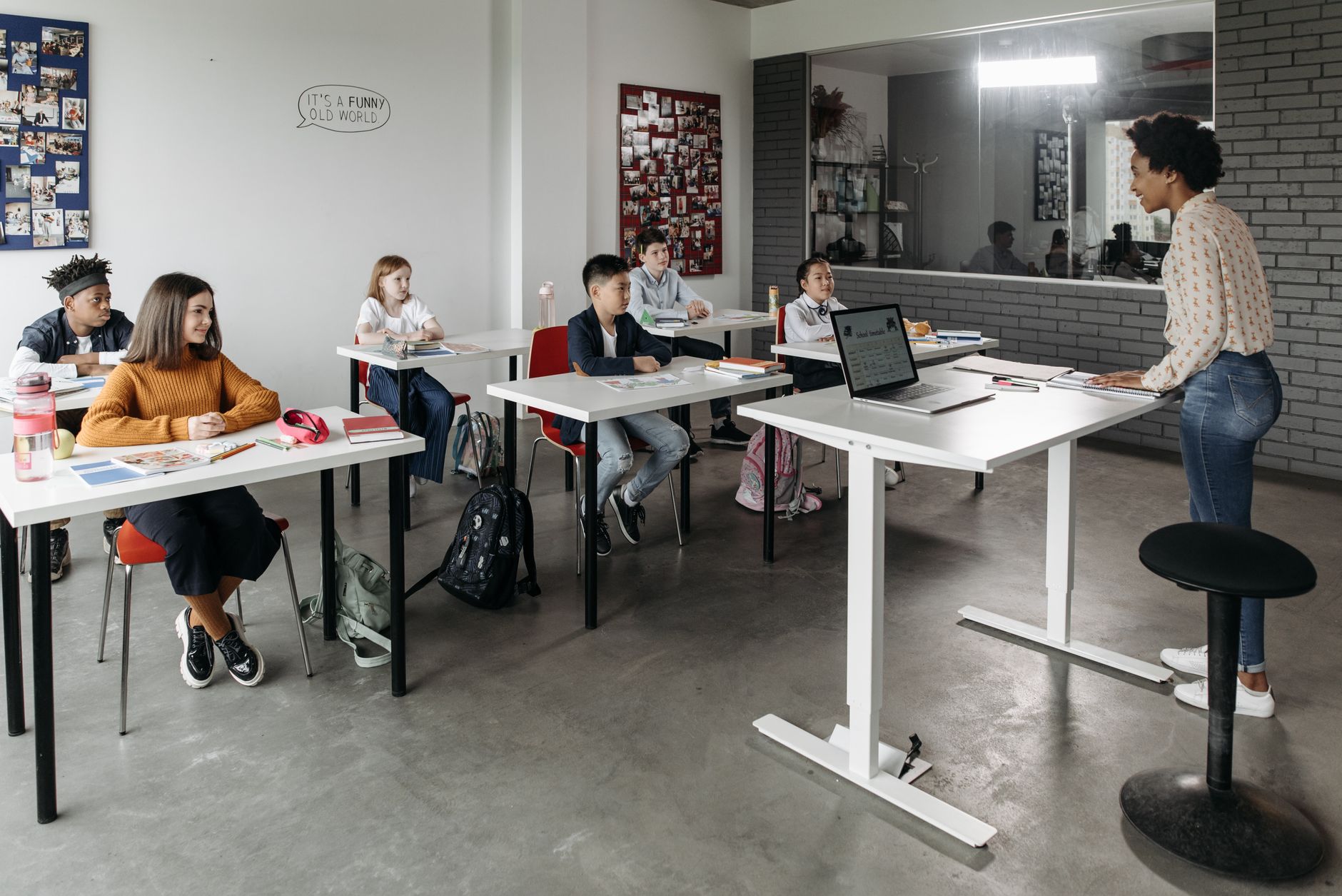 section. A minimum of 58 credits: — A diverse group of students attentively listens to a teacher in a modern classroom setting.