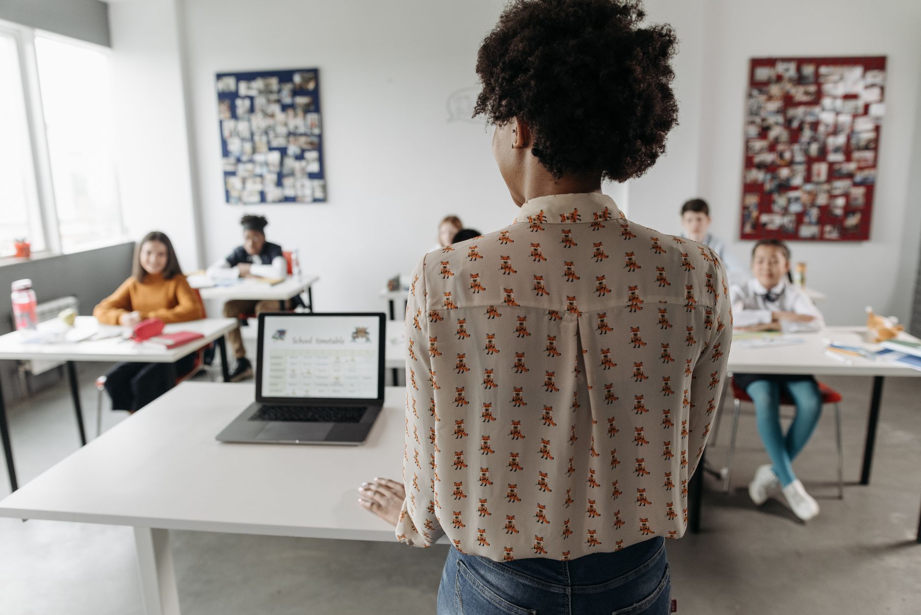 The biochemistry and biology of cells — Female teacher engaging students in a classroom setting with diverse learners.