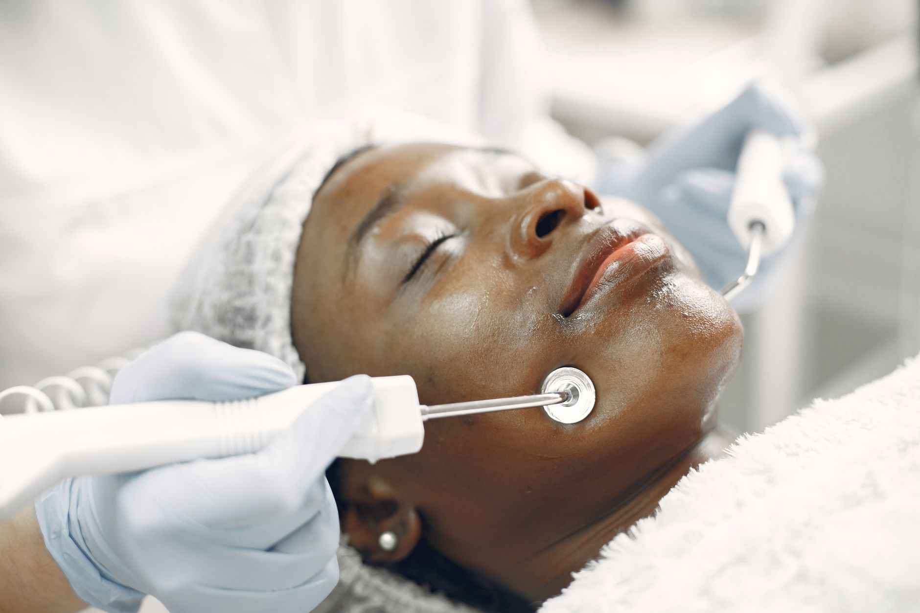 Skin disorders and diseases relative to aesthetic practice — Close-up of a woman receiving a facial skincare treatment in a spa.