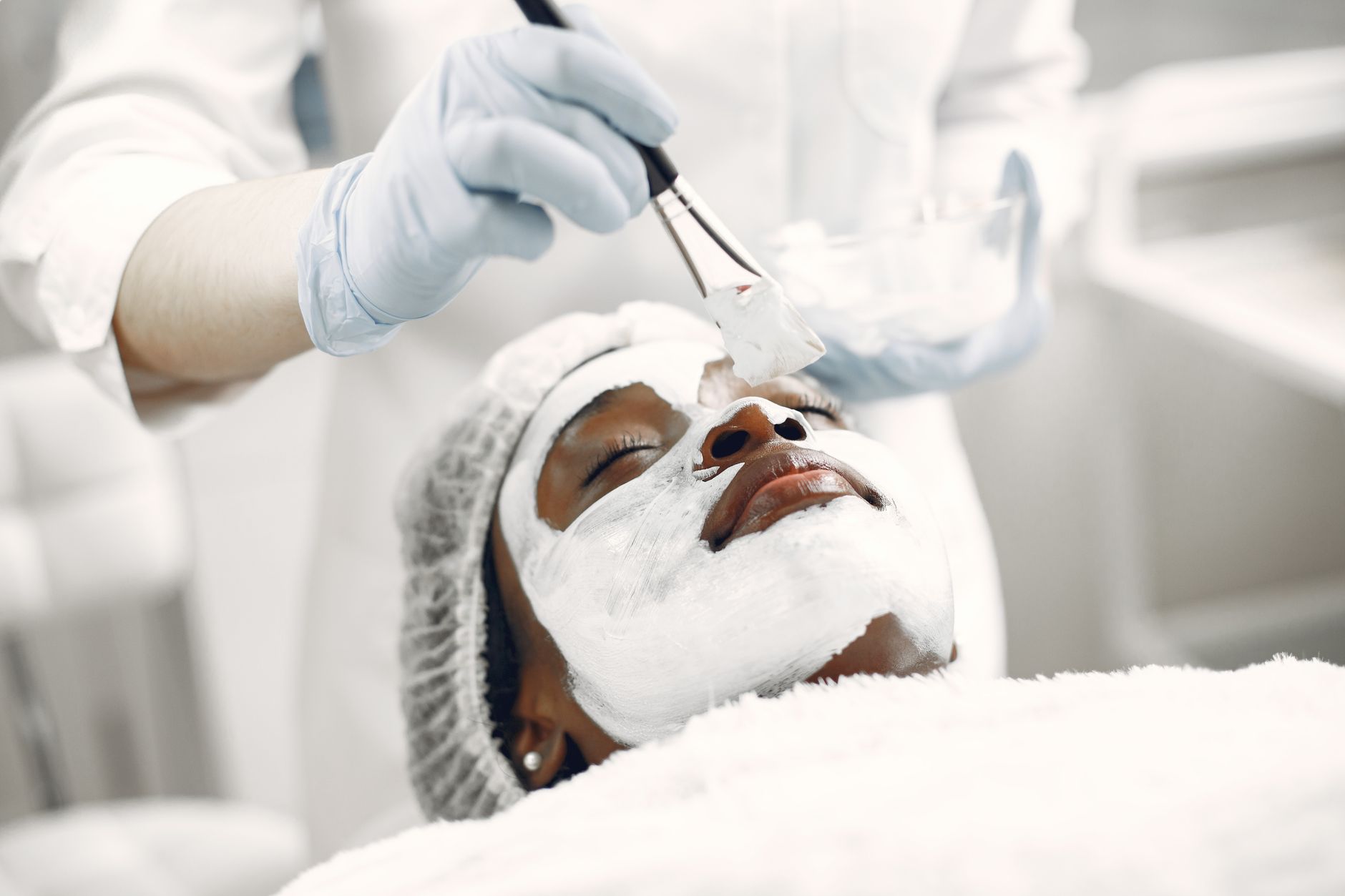 Units — A relaxing facial treatment with a face mask applied by a professional in a spa.