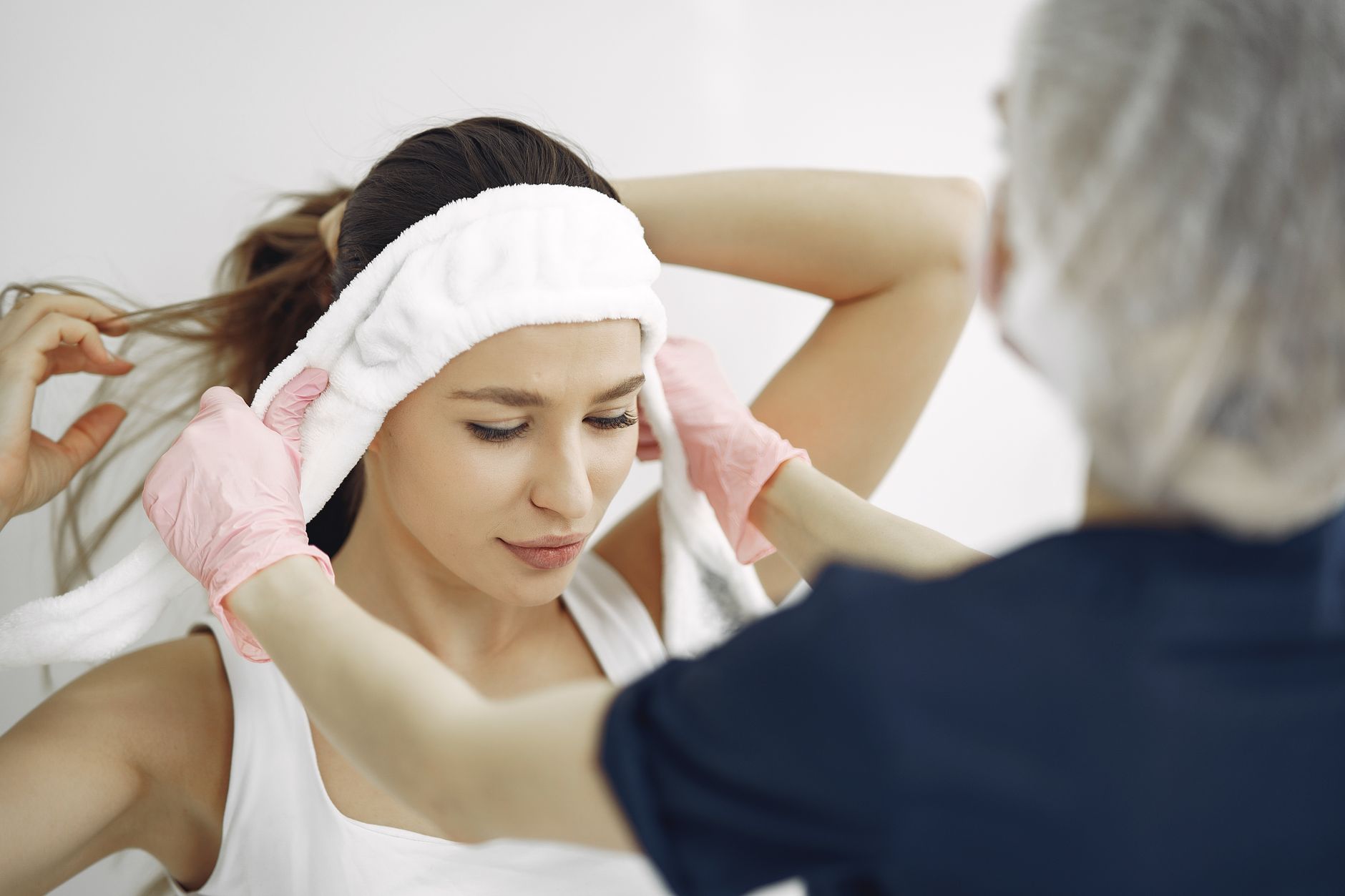 Skin rejuvenation using electrotherapy — A woman in a spa getting a facial treatment with assistance from a professional.