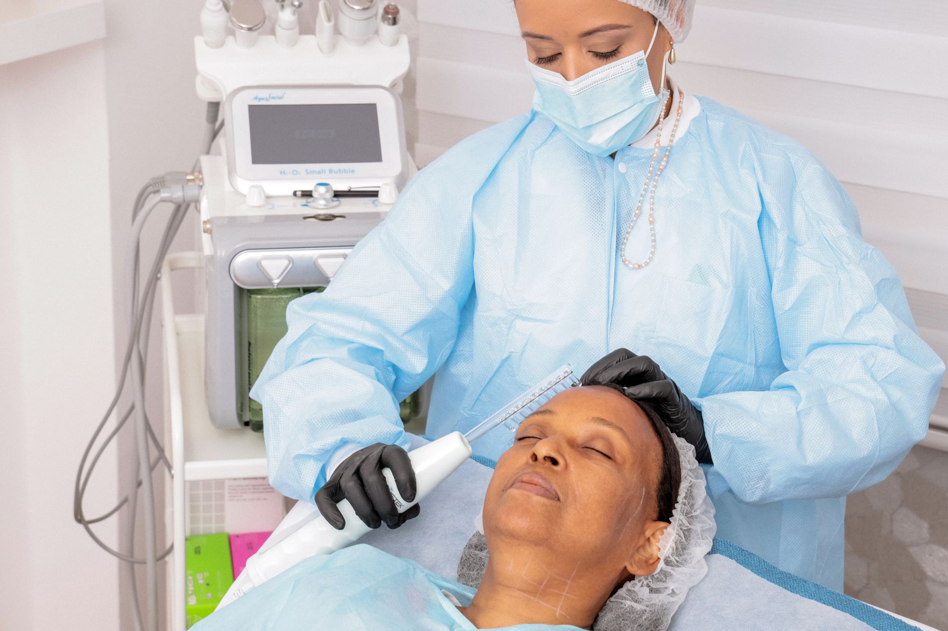 Advanced Skin Science for Aesthetic Practice — Woman receiving a professional facial treatment with advanced equipment in a spa environment.
