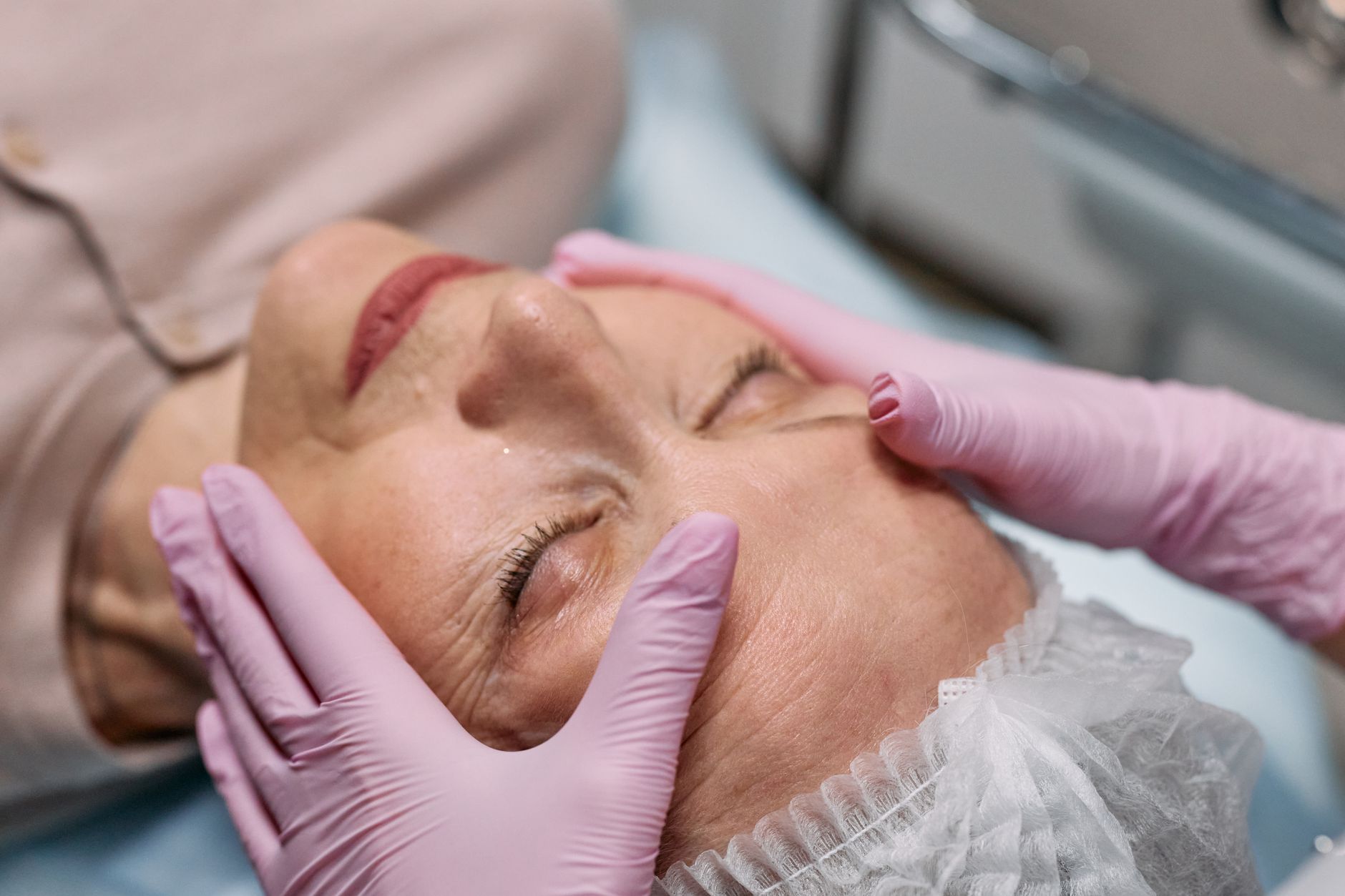 Anatomy, Physiology and Morphology of the Ageing Face — A serene spa therapy session with a senior woman enjoying a facial massage for rejuvenation.