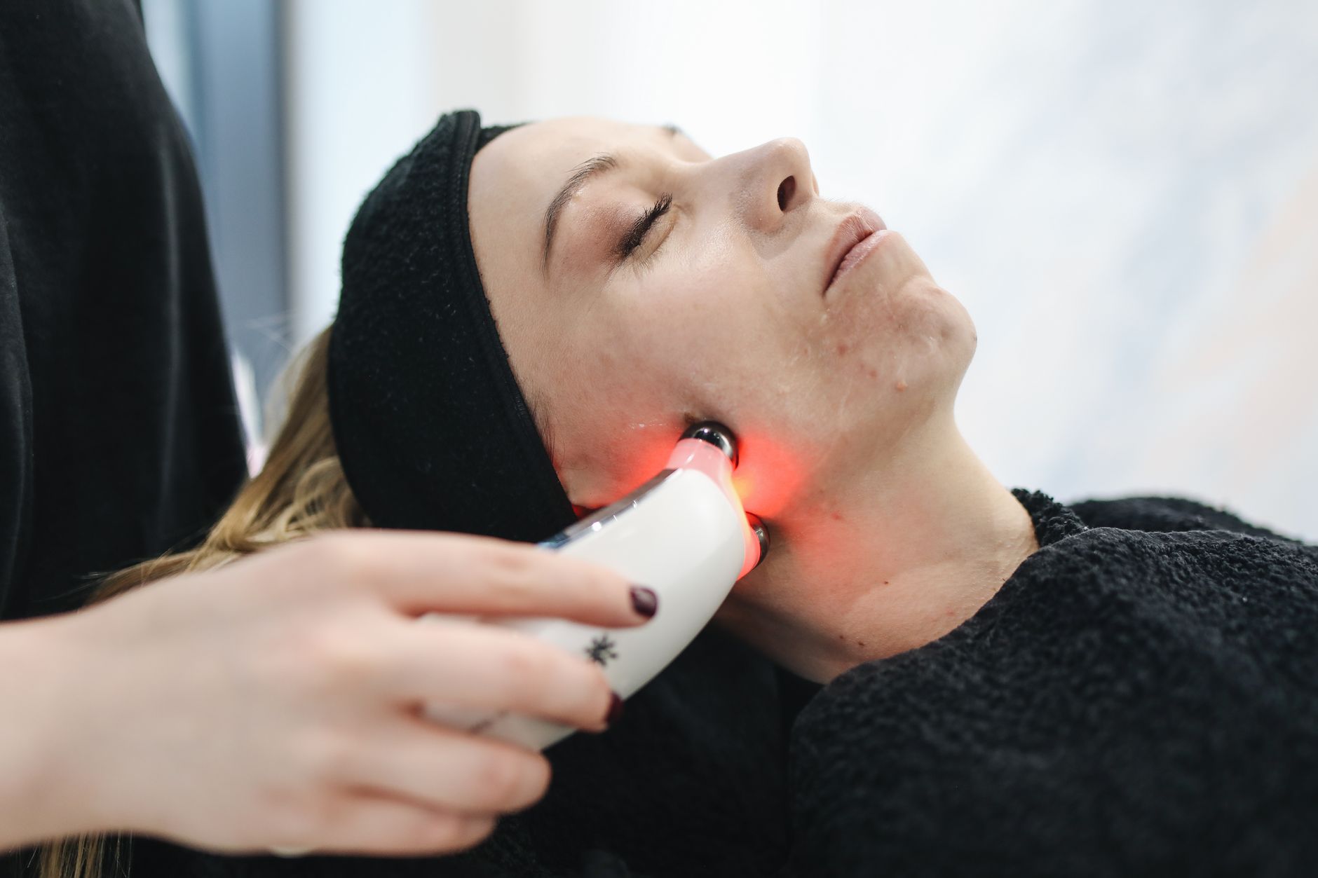 Advanced Skin Science for Aesthetic Practice — An adult woman receives a laser facial treatment in a modern skincare clinic.