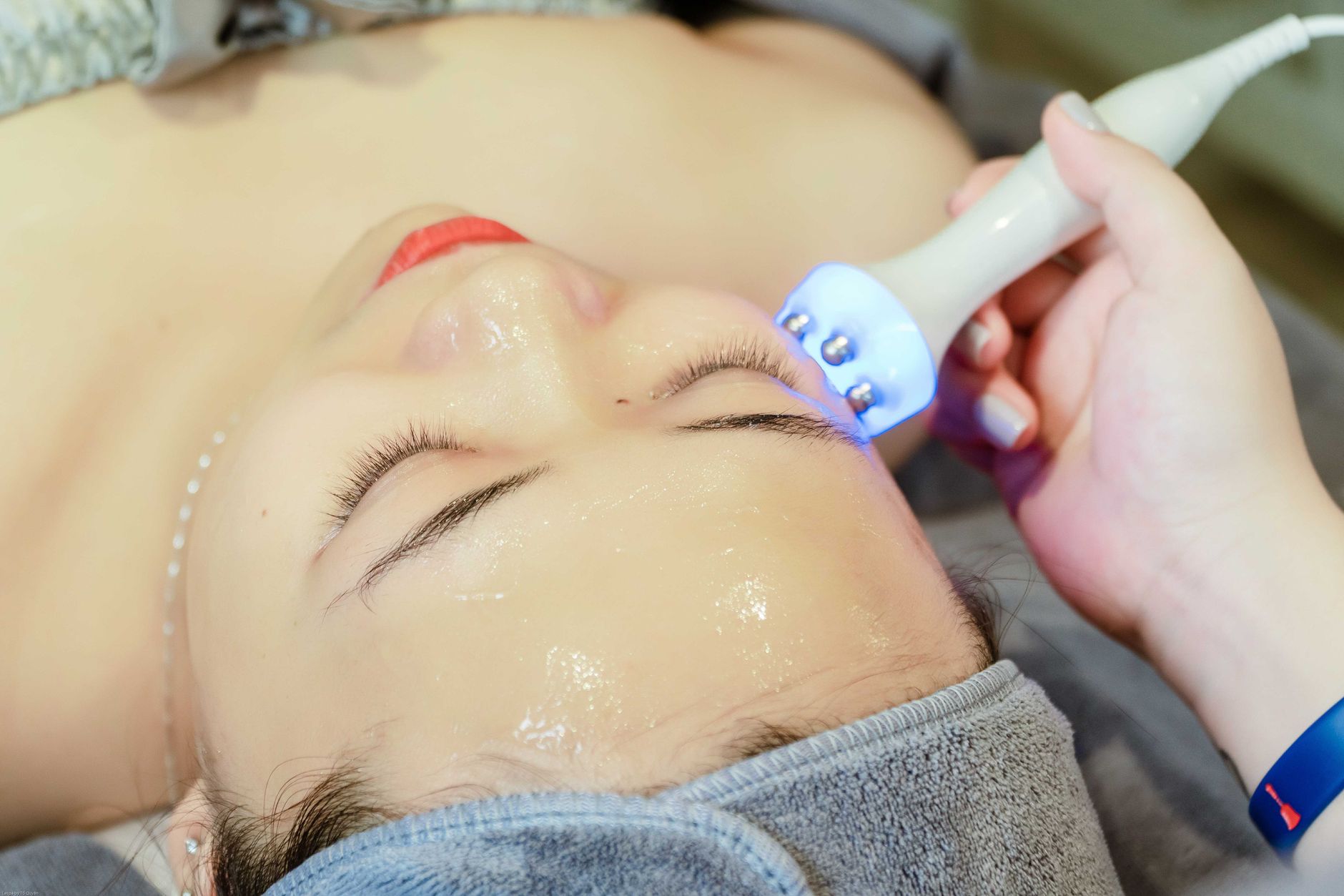 Advanced Aesthetic Procedures: Microneedling — Close-up of a woman receiving an ultrasonic facial treatment in a spa in hanoi, vietnam.