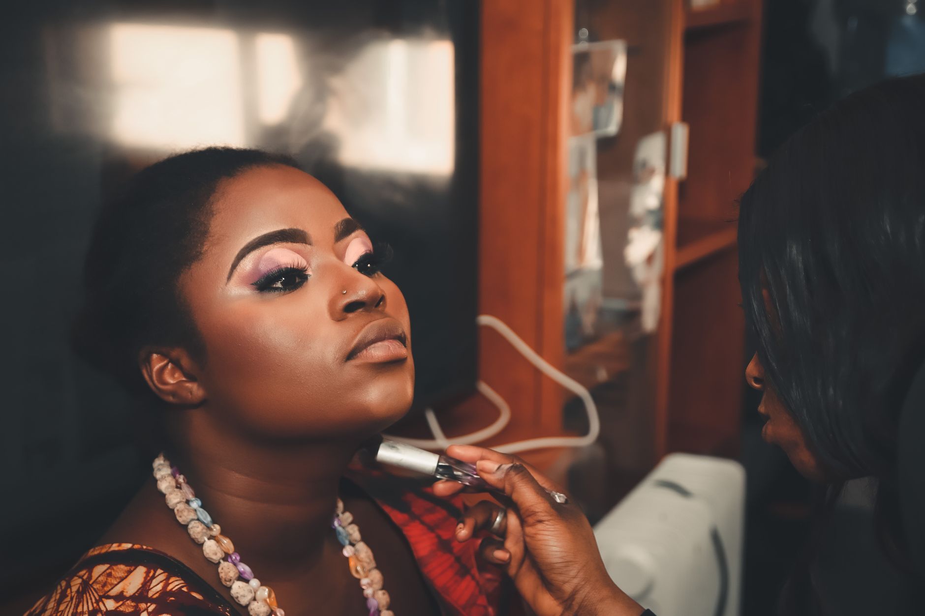 unit – 8 credits — A woman receiving a professional makeup session in a beauty salon. enhances facial features with a touch of elegance.