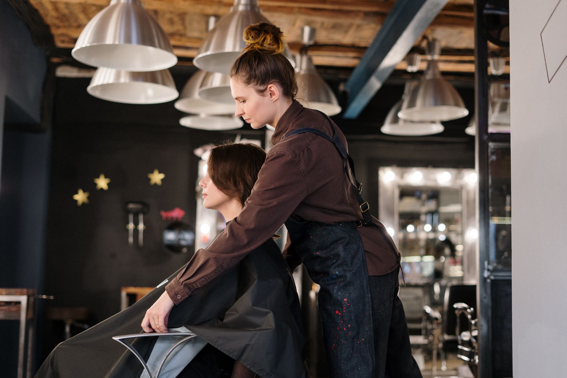 unit – 1 credit. — Hairdresser styling a client's hair in a contemporary salon setting.