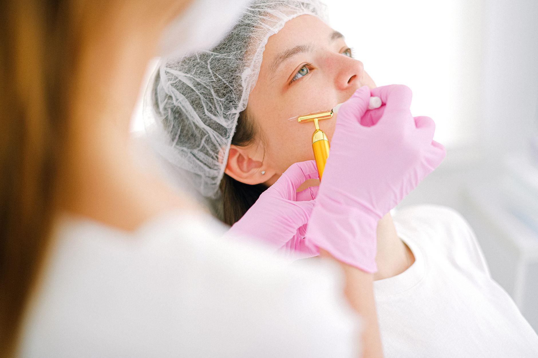 Advanced Aesthetic Procedures: Skin Boosters — Close-up of a woman receiving a facial treatment at a beauty spa.