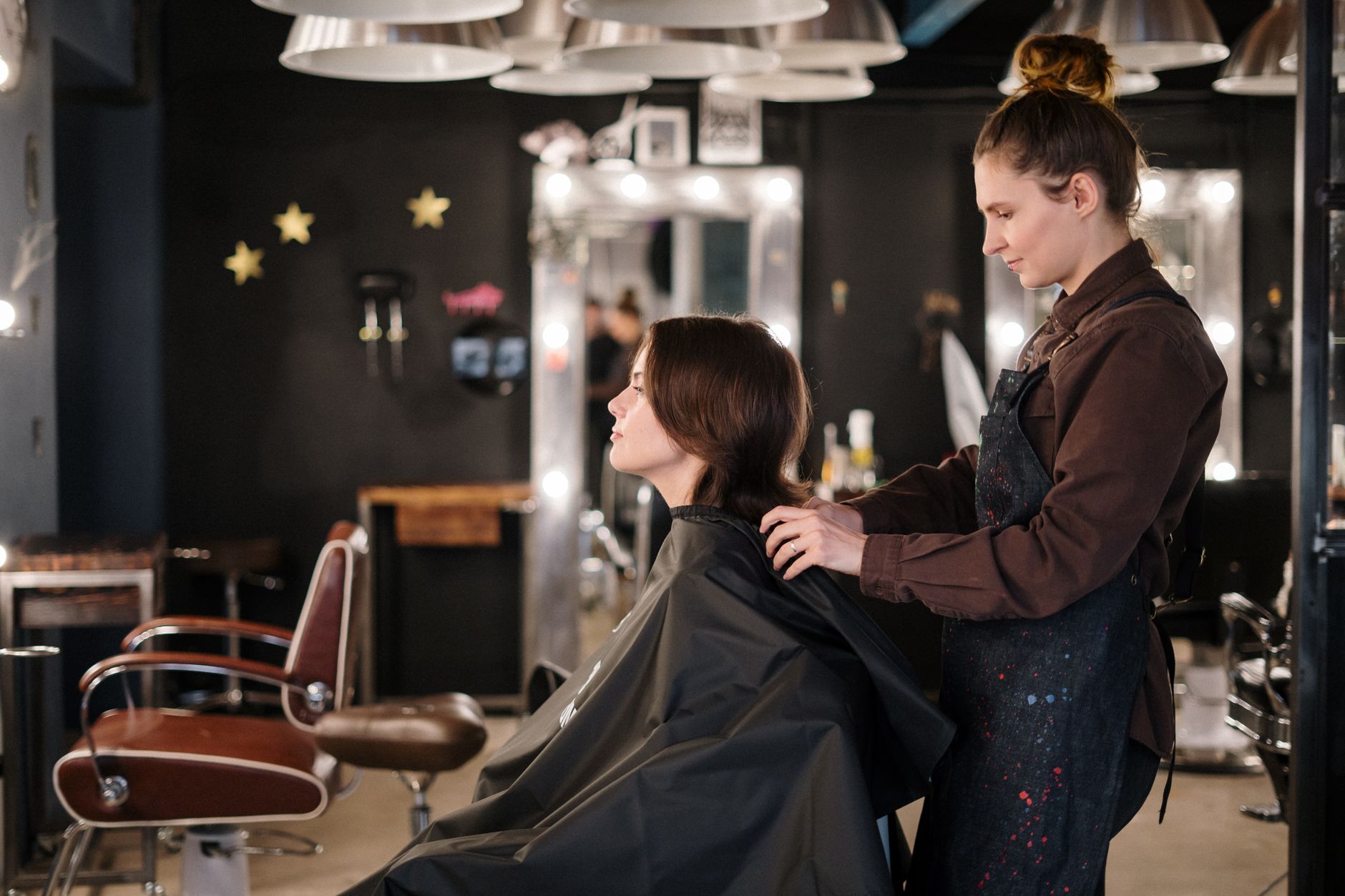 unit – 1 credit — A hairstylist trims a client's hair in a modern salon setting, capturing a moment of focus.