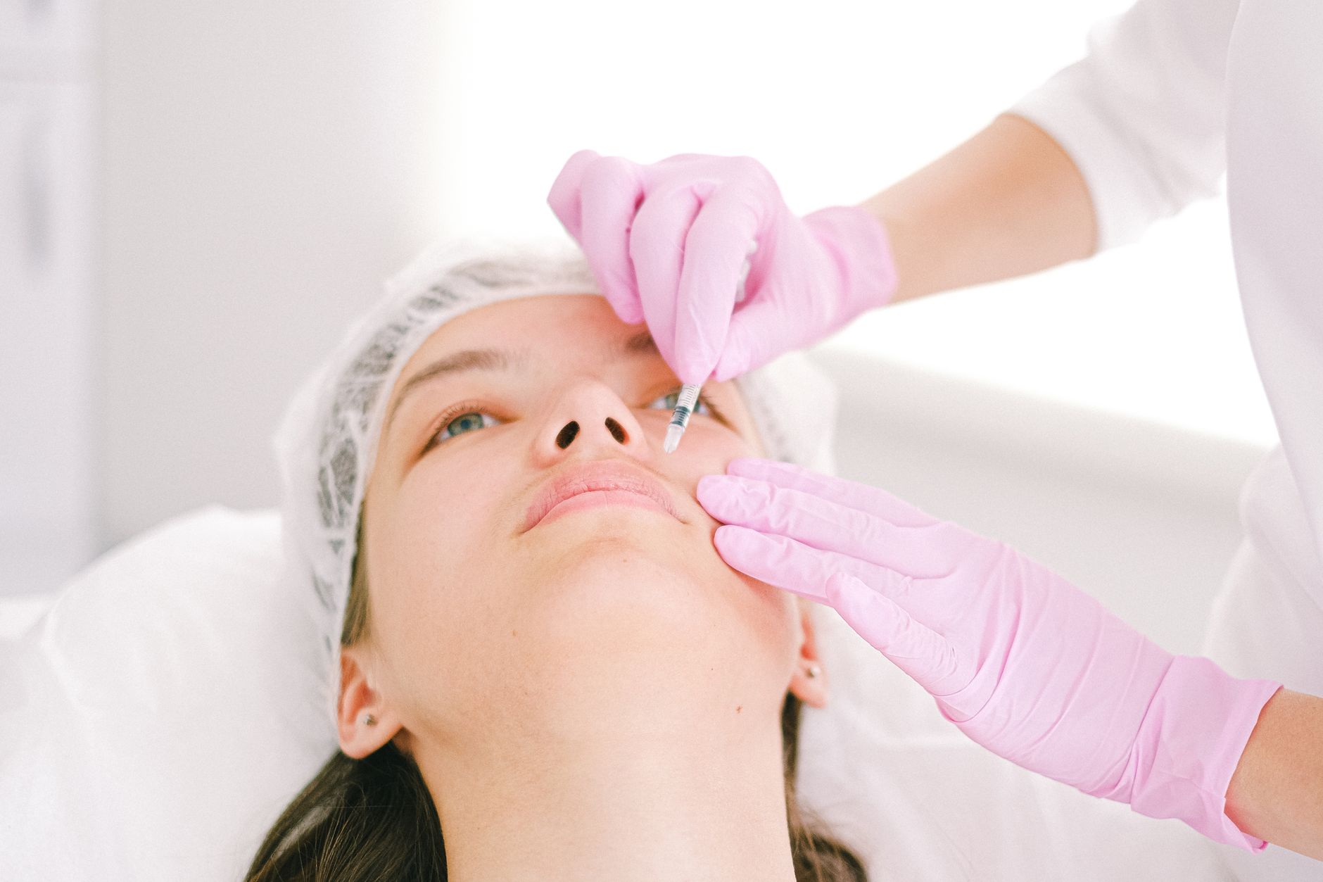 Advanced Aesthetic Procedures: Combining Radio Frequency and Micro-needling — Woman receiving a facial cosmetic injection in a professional clinic setting.