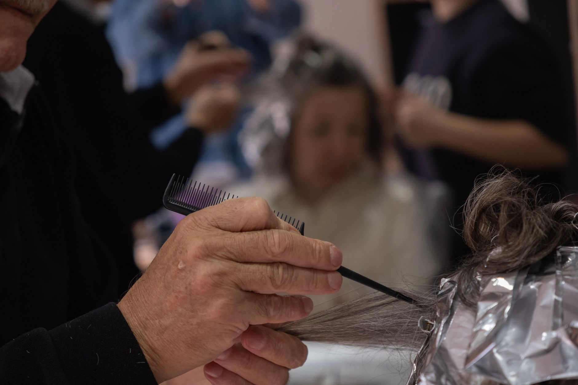 Basic business support — Hair salon scene with a hairdresser using foil and comb for highlights.