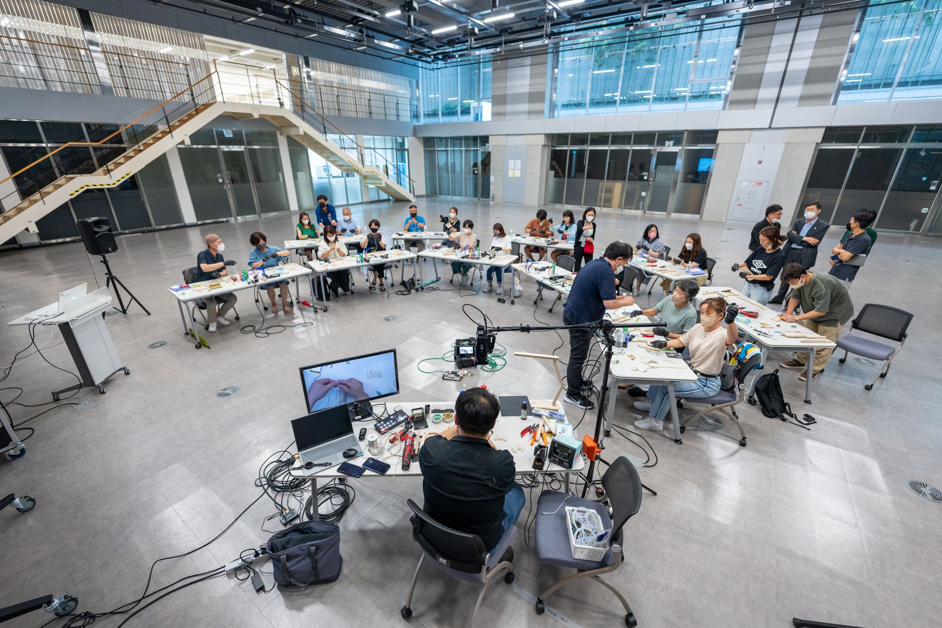 The Gut and Microbiome — Wide shot of students in a modern university classroom engaging with technology and learning.