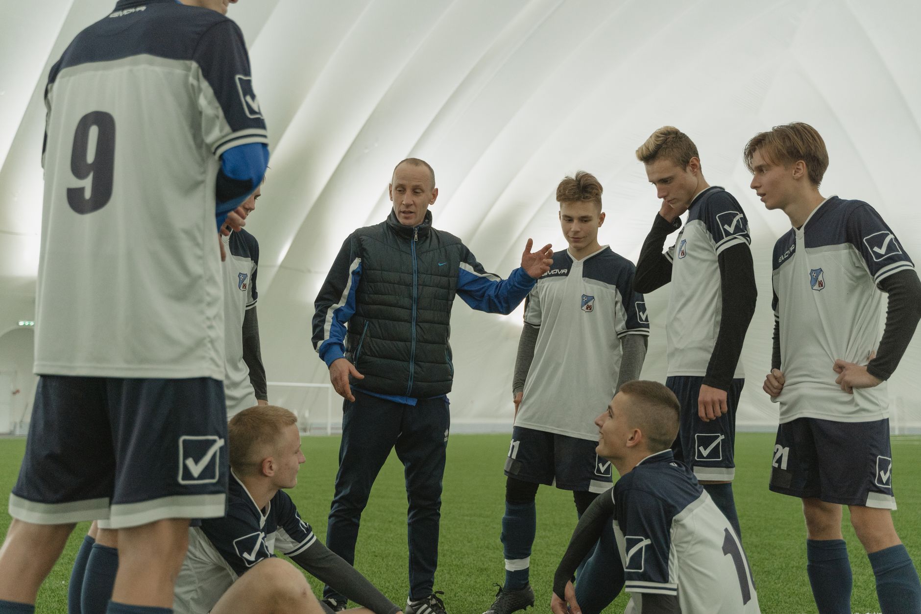 Botanical Healing; An Introduction to Herbal Medicine — A coach passionately instructs his soccer team during a practice session inside a sports dome.