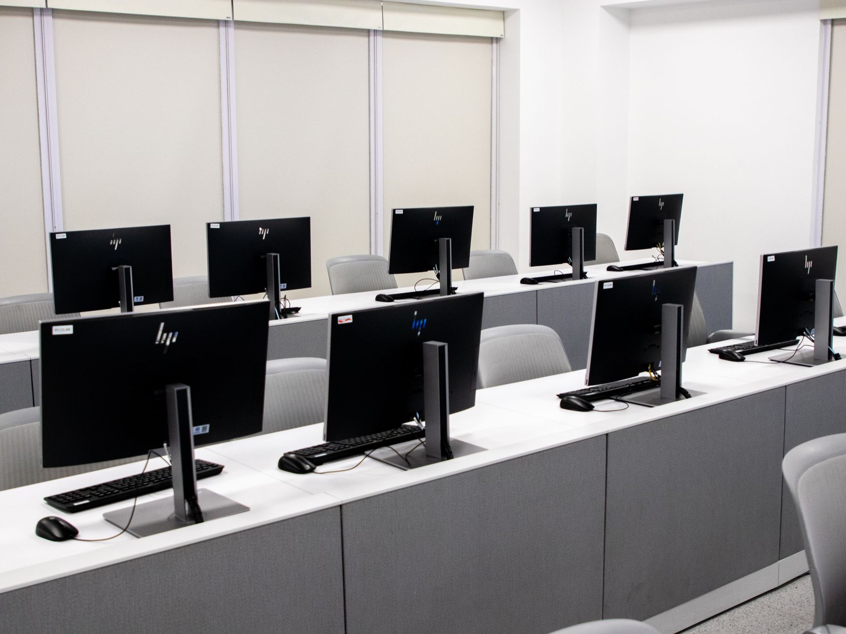 The Gut and Microbiome — An empty computer lab with modern desktop setups and ergonomic chairs.