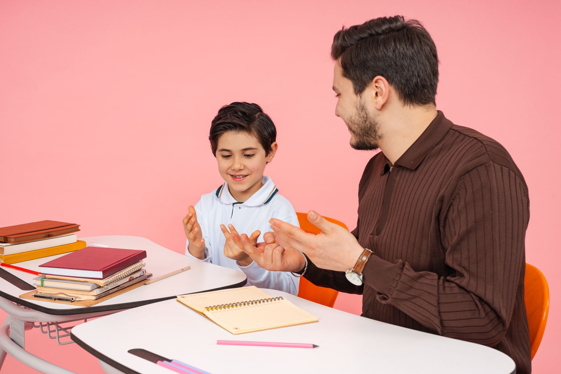 The Scope of Psychology — Male teacher and young student enjoying a learning session in a classroom.