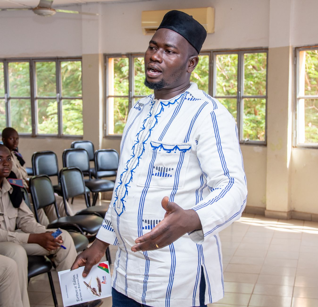 Biopsychology — Confident man speaking passionately in a classroom setting.