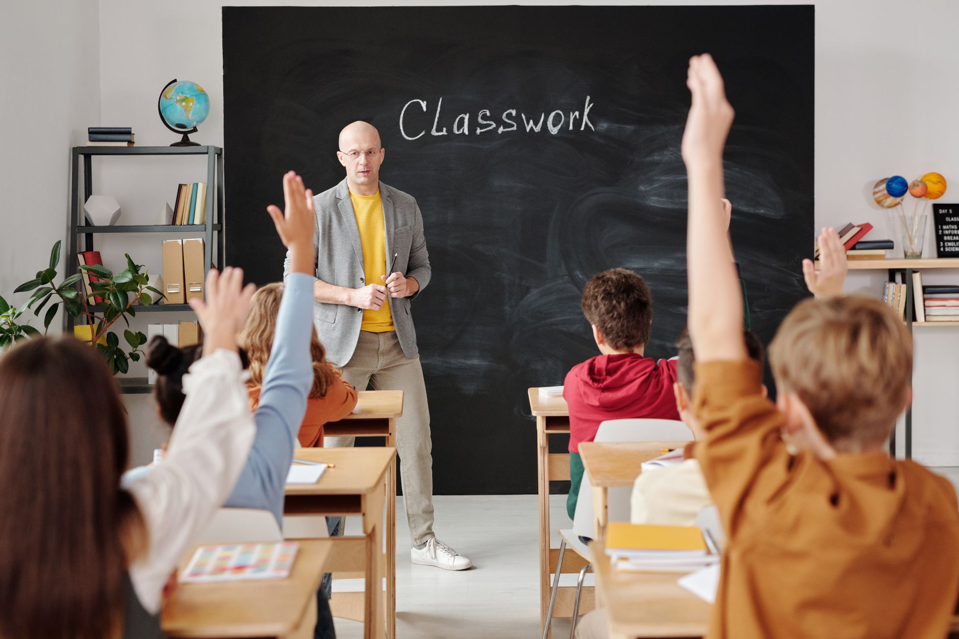 Processes Of Human Memory — A teacher interacts with diverse students in a classroom, engaging them in active learning.