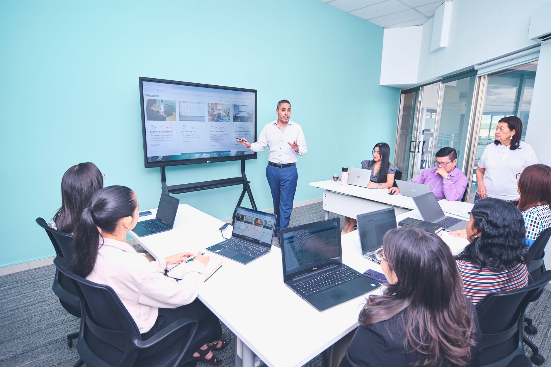 Psychological Approaches to Depression and Schizophrenia — Team engaged in a presentation at a modern office using digital technology.