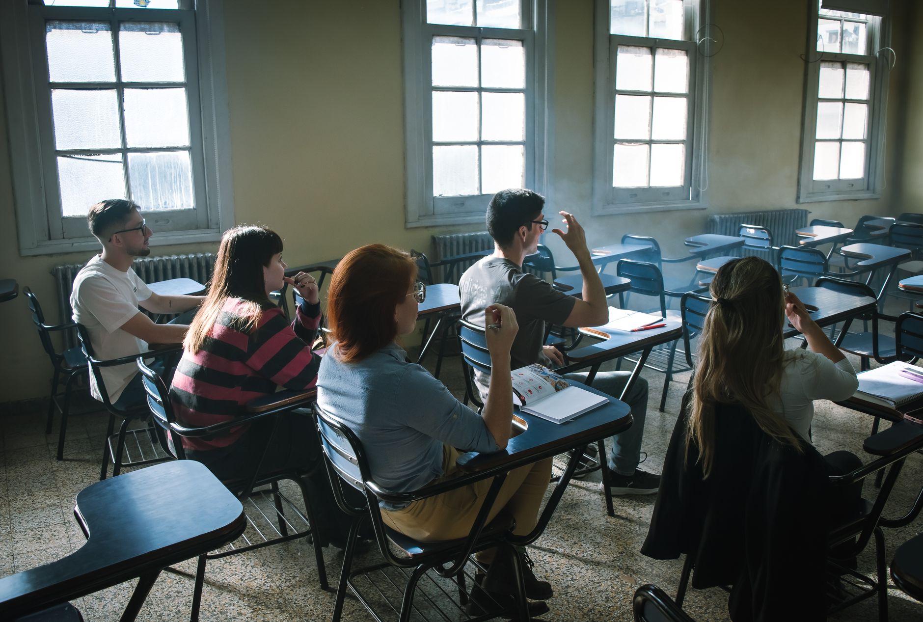Social Psychology: Pro and Anti-Social Behaviour — Students sitting in a bright classroom, attentively listening and taking notes.