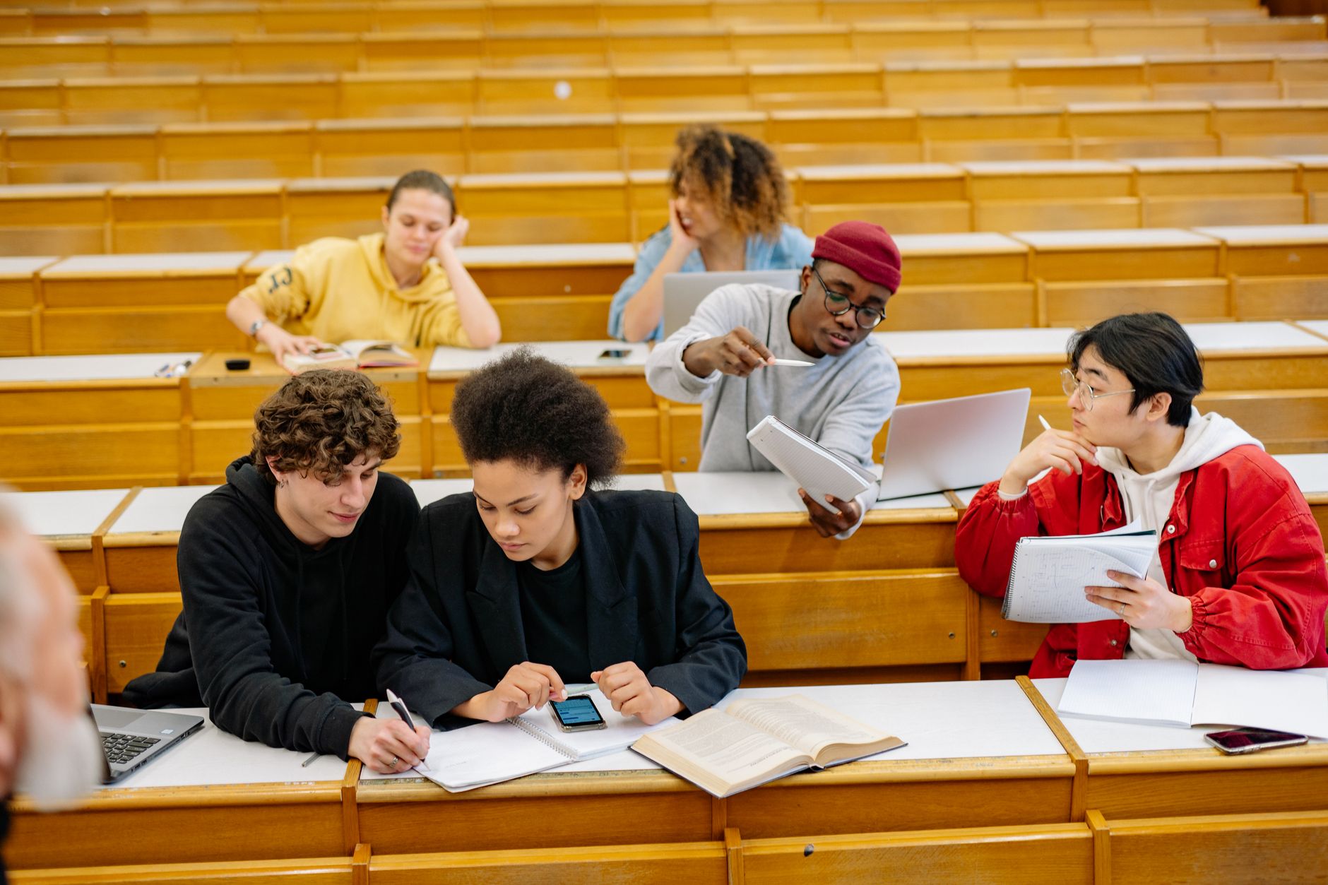 The Diversity of Addiction — A group of diverse students collaborating and studying together in a classroom setting.