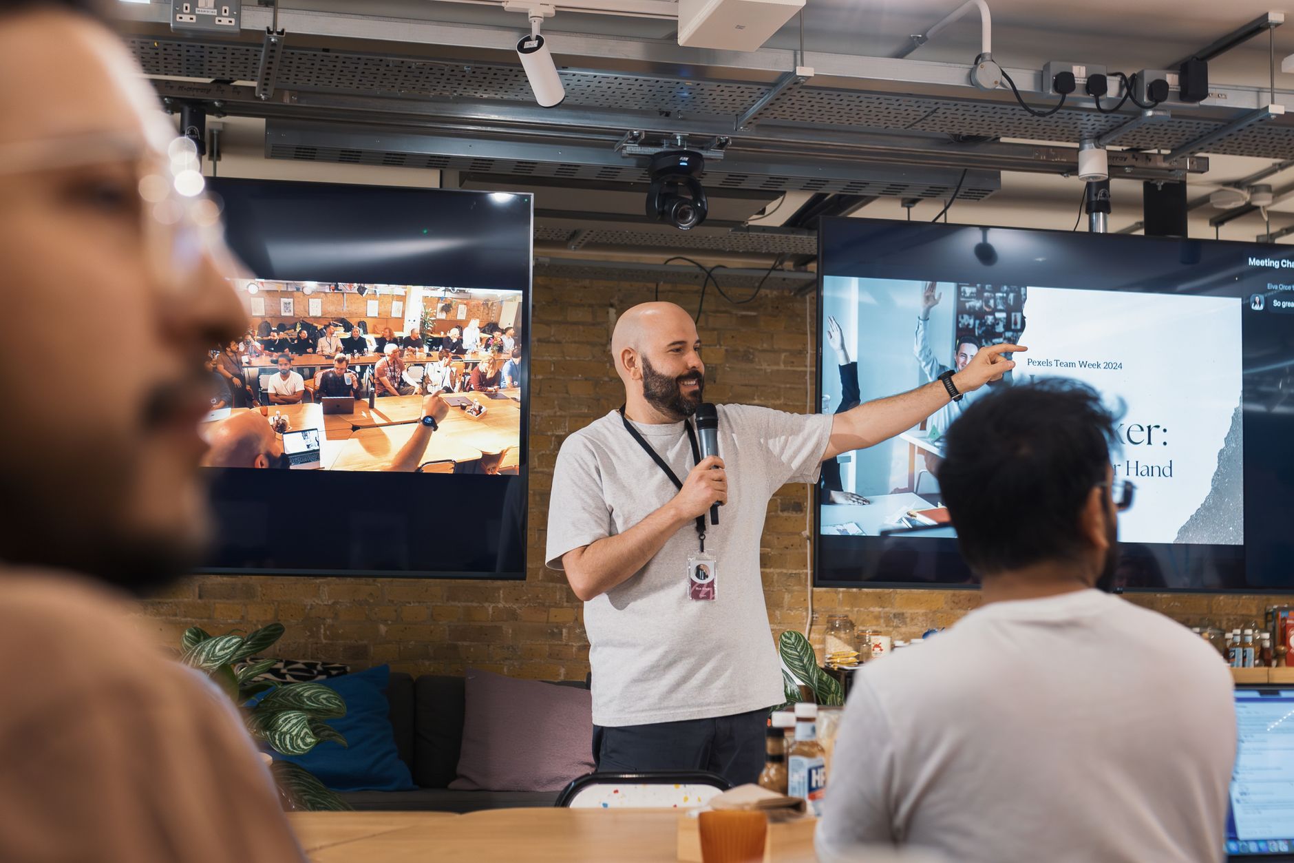 Resourcing, Talent Management and Development — Team leader delivering a presentation in a lively office environment. dynamic and collaborative setting.