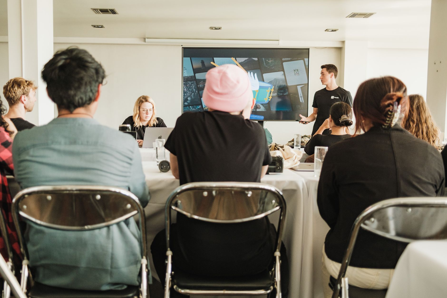 Employee Relations — A diverse team in a modern office setting, collaborating during a meeting with a presentation.