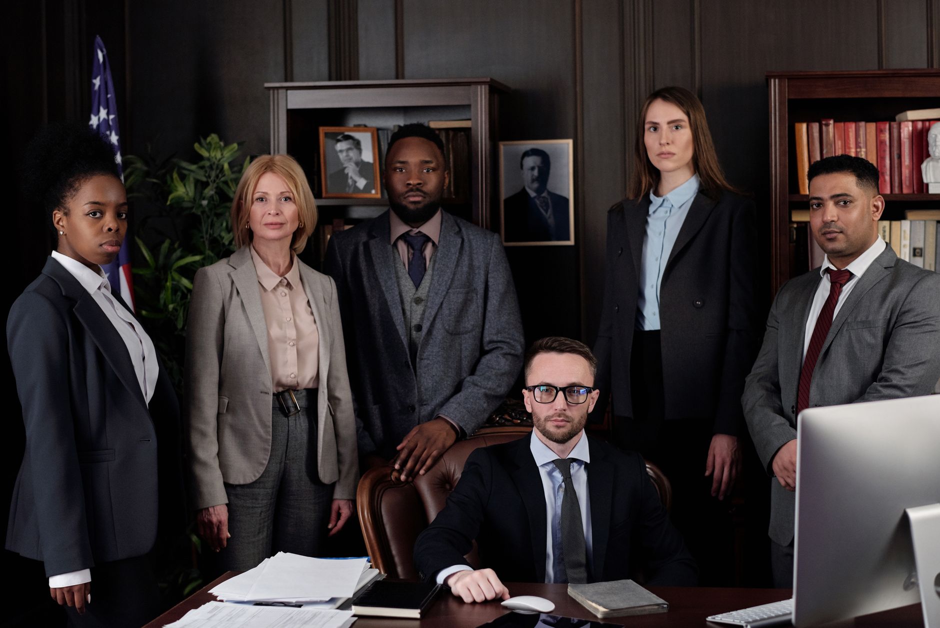 Public Law — A diverse group of business professionals posing in an office, showcasing teamwork and leadership.