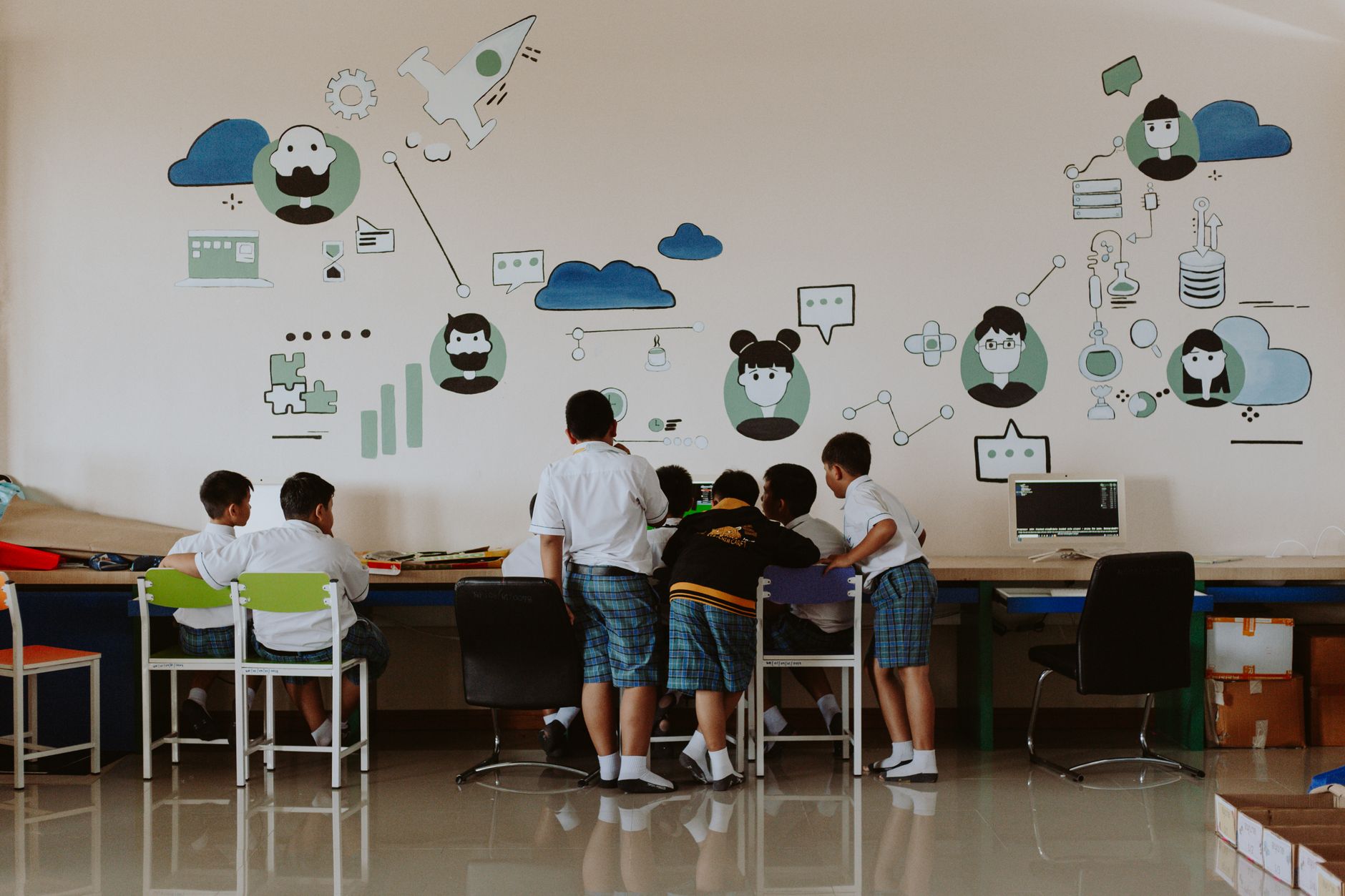 Visualisation — Students exploring technology in a colorful classroom environment, fostering education.