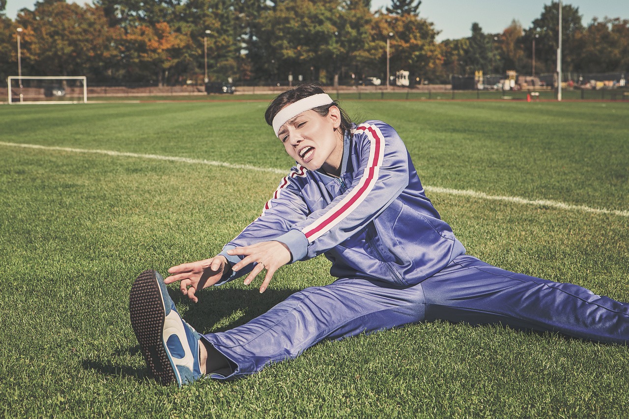 Gastrointestinal and Immune Health in Athletes — Stretching, sports, woman, athlete, fitness, sport, healthy, exercise, workout, young, female, body, lifestyle, training, fit, nature, health, stretch, people, active, girl, adult, person, sportswear, athletic, gym, exercising, physical, sporty, white, pilates, leisure, tracksuit, track and field, shoes, headband, grass, field