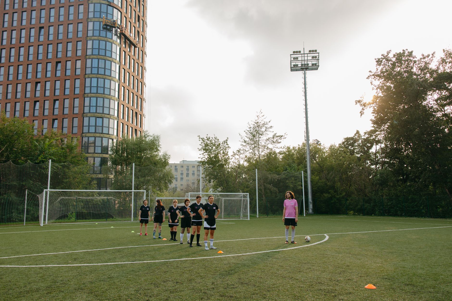 Fielding Coaching in Cricket — Female athletes training on a soccer field with focus on teamwork and coaching outdoors.