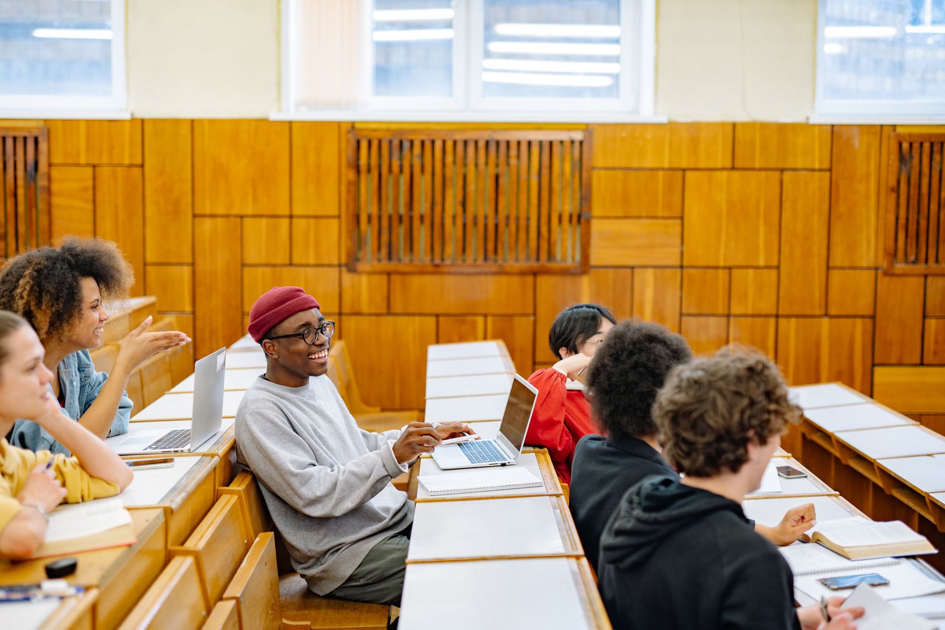 Understanding the Principles and Practices of Externally Assuring the Quality of Assessment — Students engaging in a lecture, illustrating diversity and collaboration in a classroom environment.