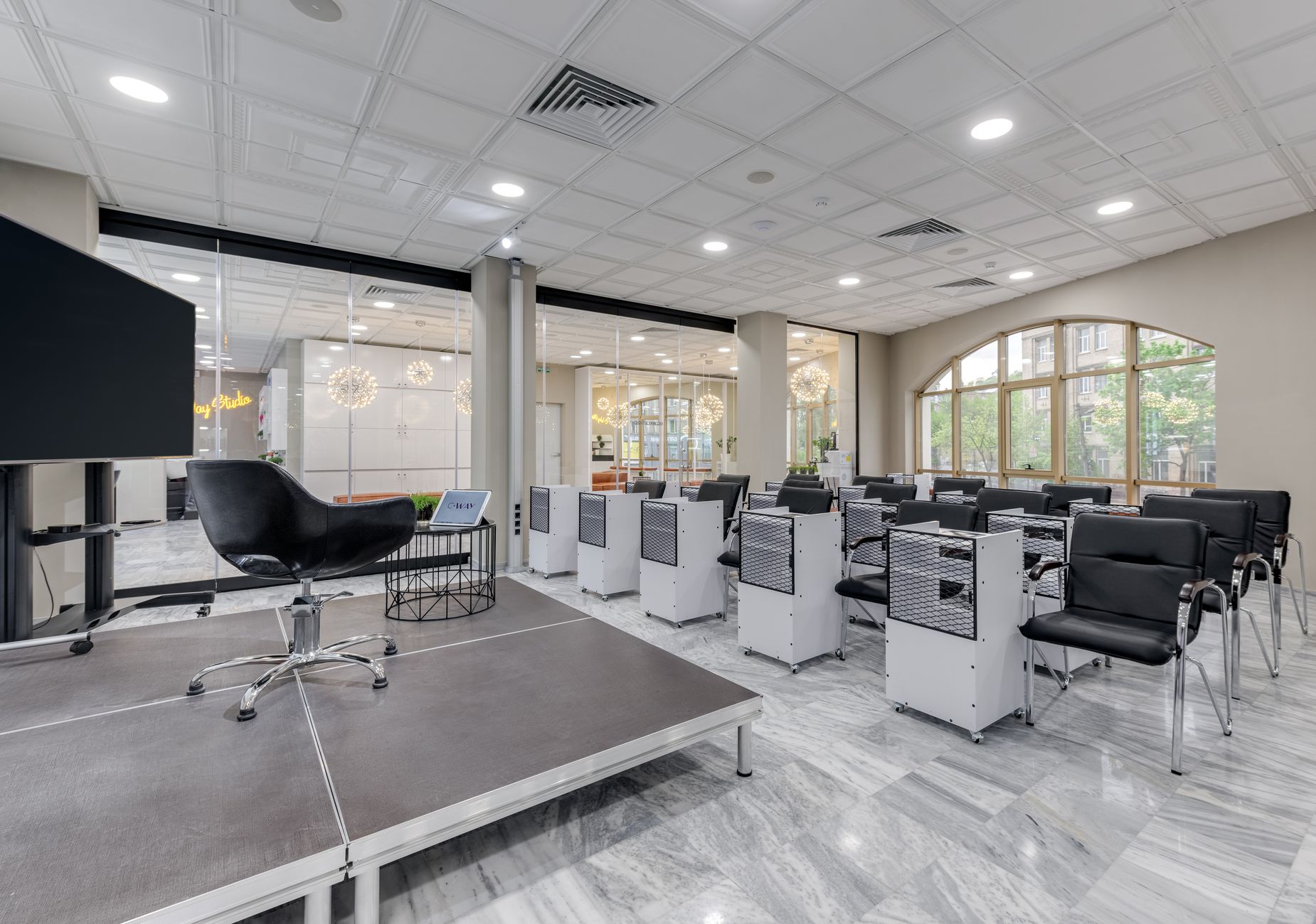 Lash lifting and brow lamination — Spacious conference room with podium, chairs, and glass partitions featuring modern design elements.