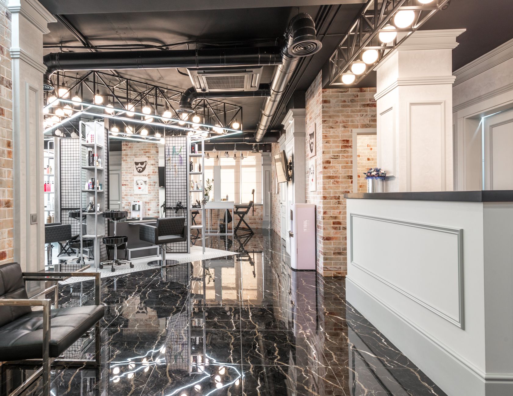 Advise on products and services — Reception counter placed in spacious stylish beauty salon with black chairs and decorated bricks walls with paintings under bright illumination