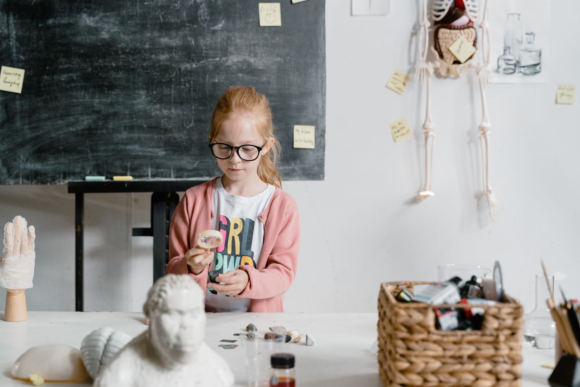 Anatomy, physiology and pathology — Girl experimenting with rocks in a classroom. engaged in scientific learning and exploration.