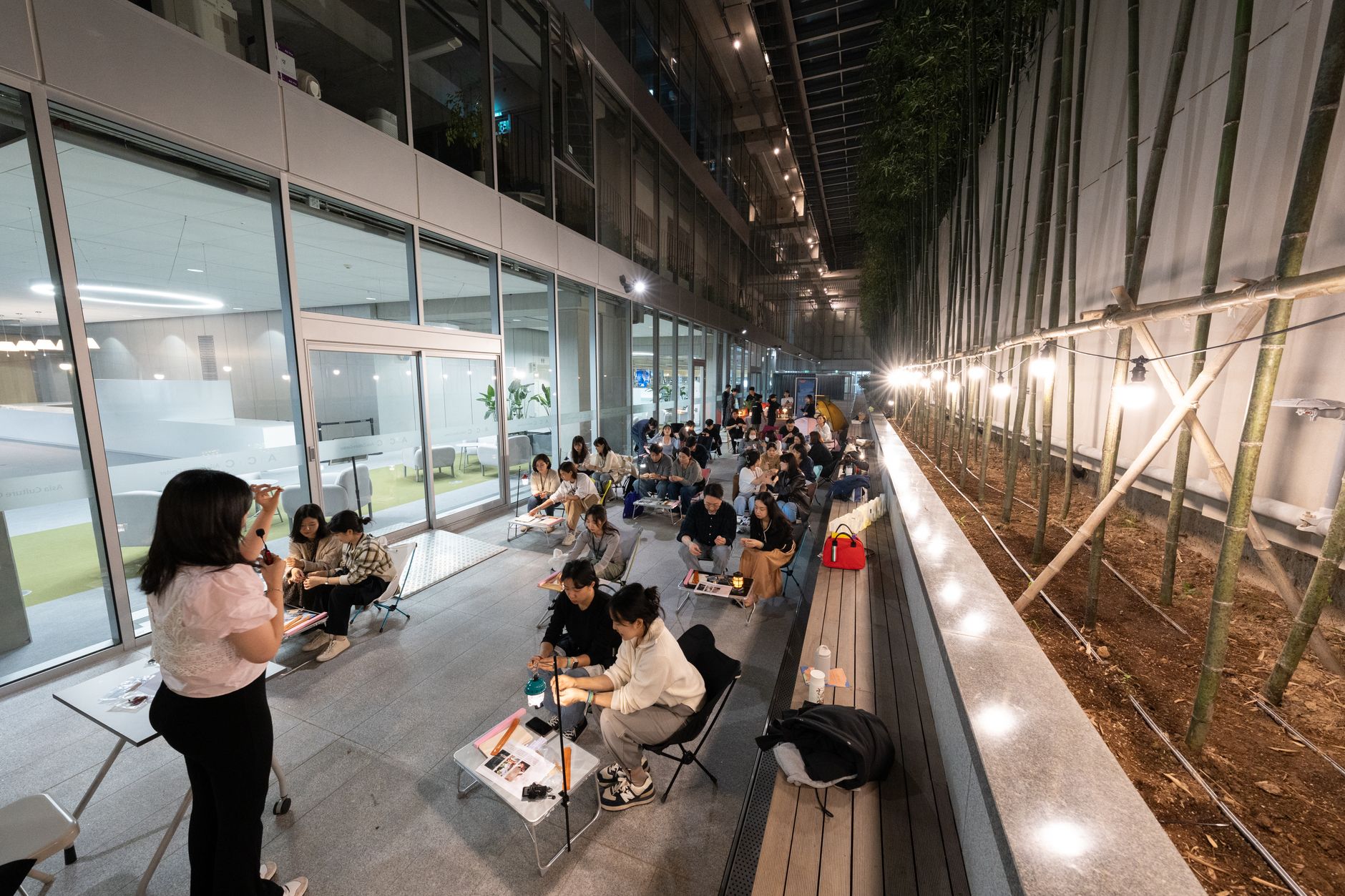 Epilation — A nighttime educational workshop with instructor and engaged students in outdoor setting.
