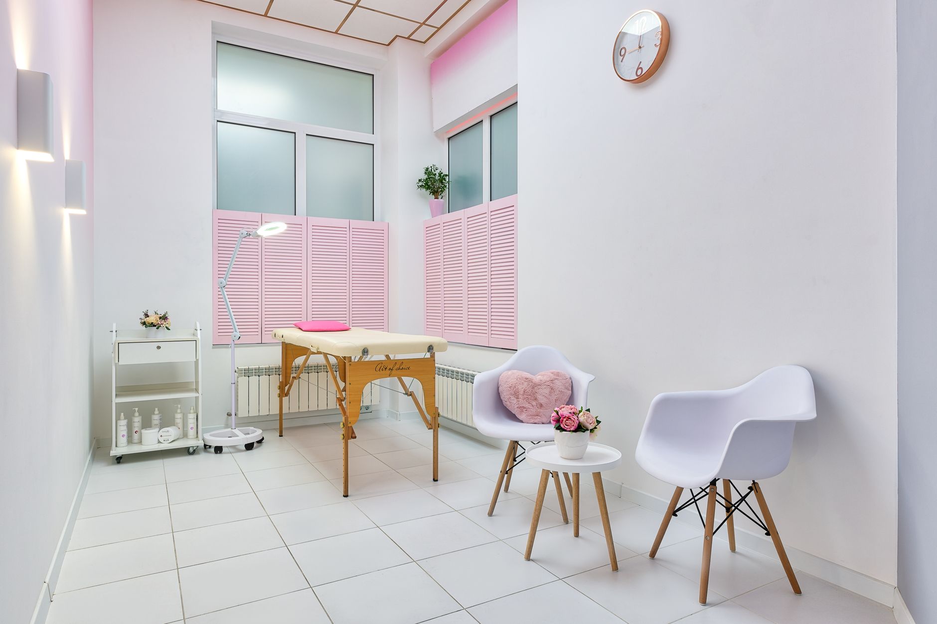 Intimate waxing — Interior of beauty salon with table for spa procedures and set of skincare products and flower decorations