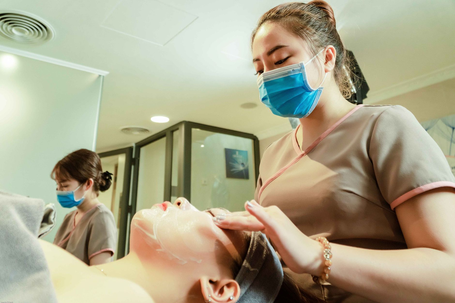 Health, safety, and hygiene — Women receiving facial treatments in a hanoi spa, showcasing relaxation and wellness.