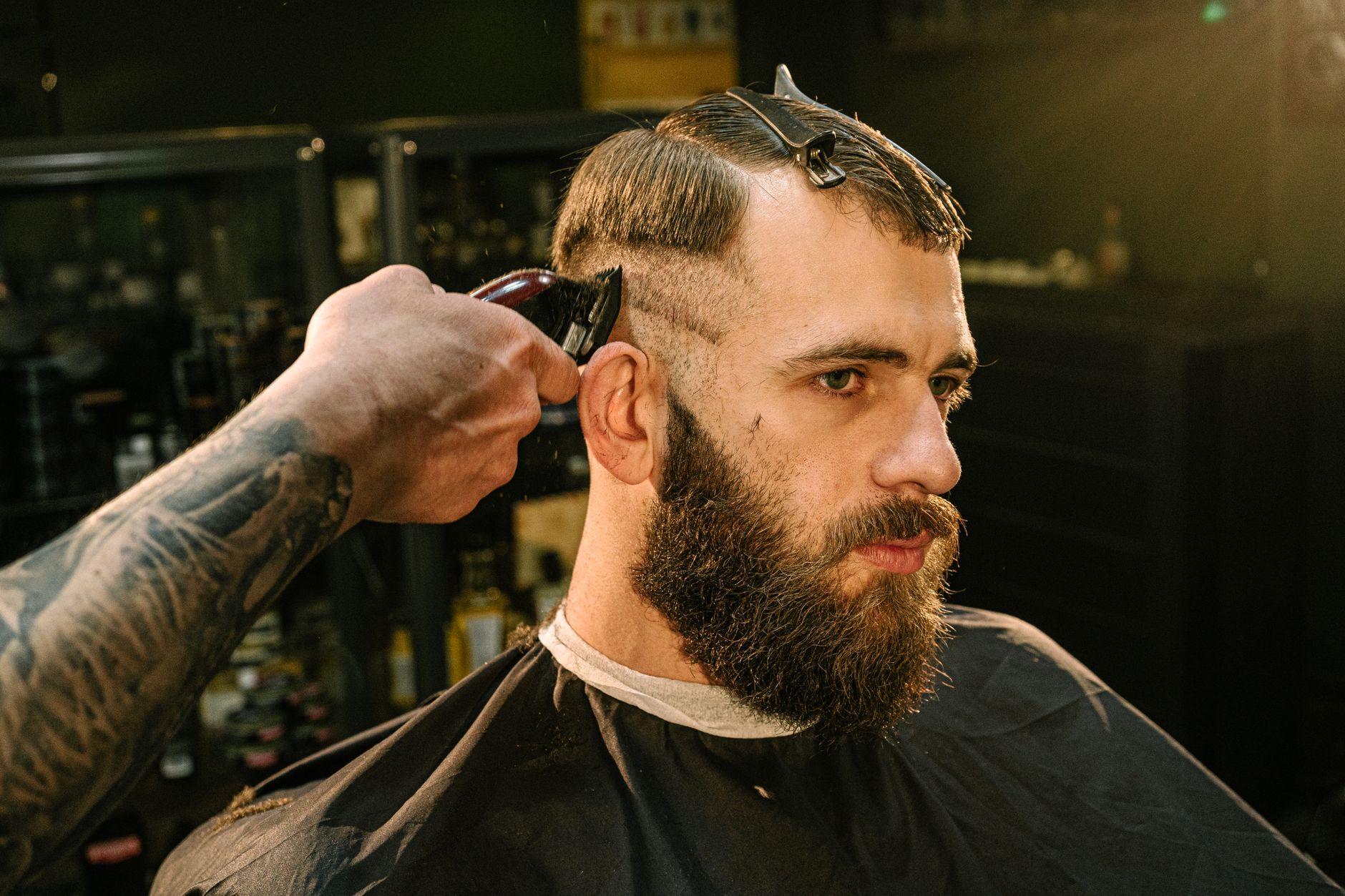 Cut hair — Professional haircut and beard grooming session in a barber shop captured in detail.