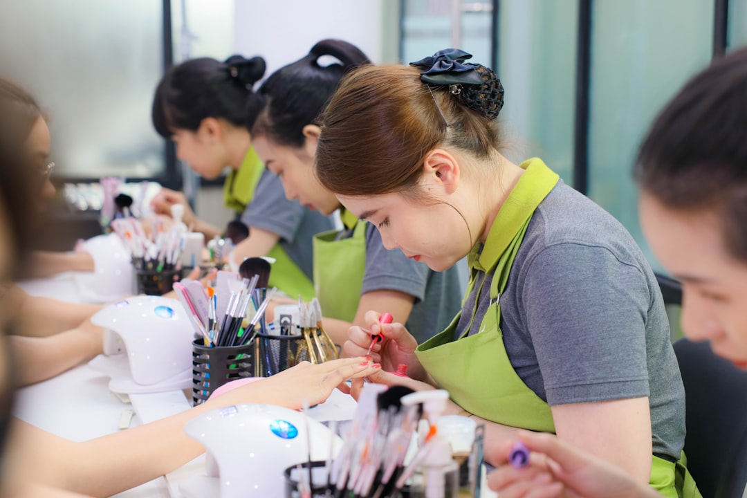 Advise on products and services — A group of women sitting at a table with makeup brushes