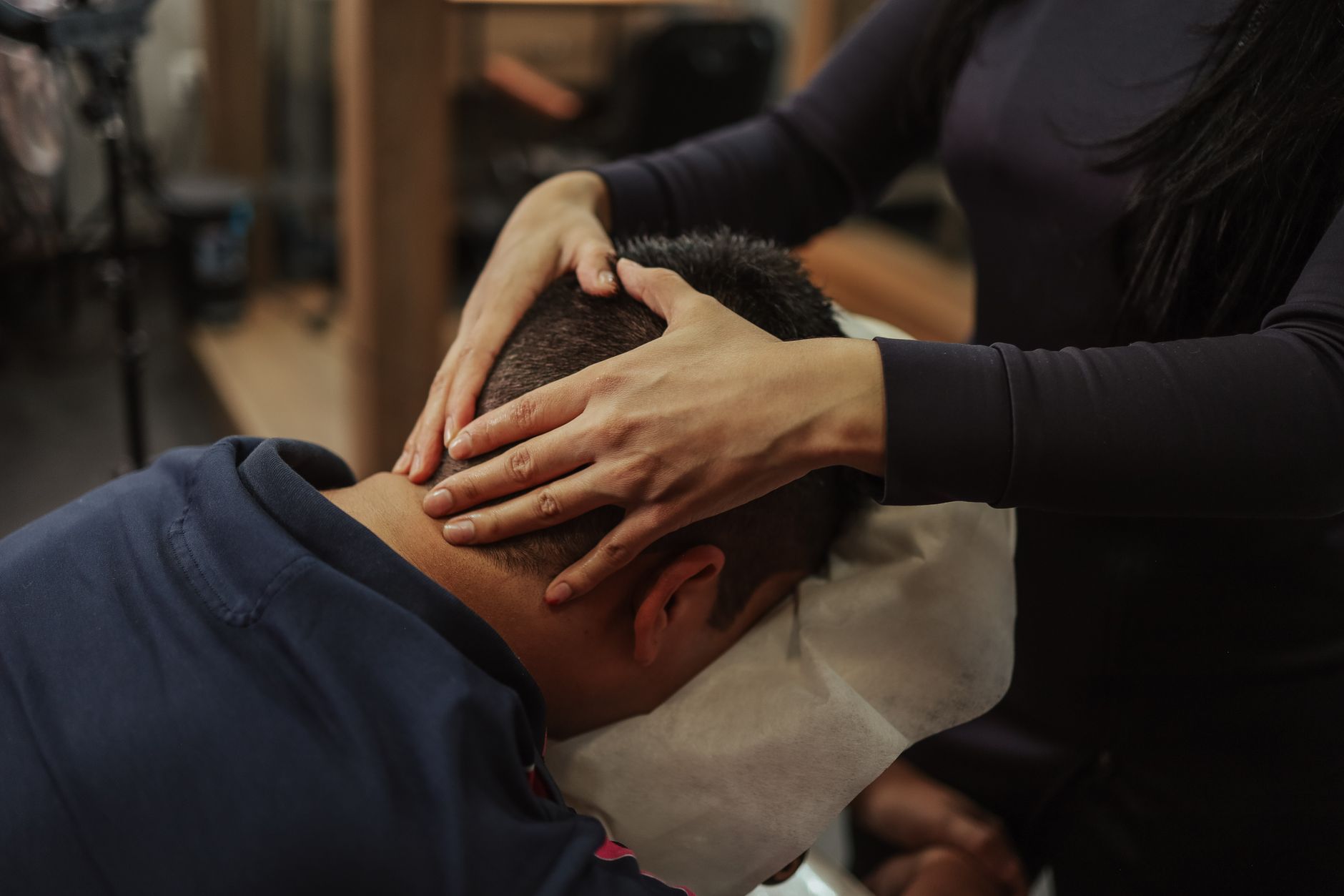 Relax hair — A person receiving a soothing head massage at a salon, creating a calming experience.