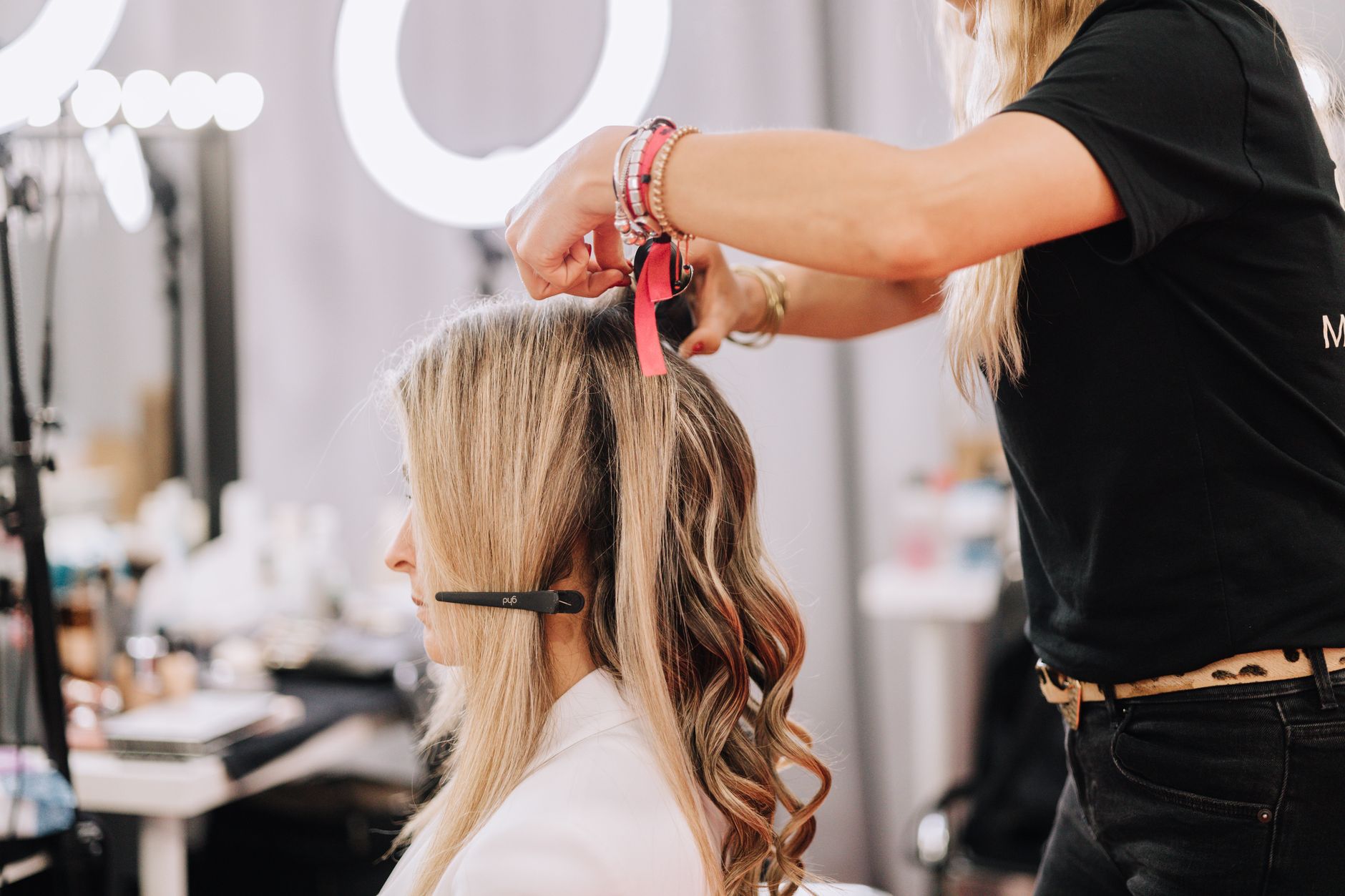 Hair extensions — A stylist working on a blonde woman's hair during a studio session in barcelona, spain.