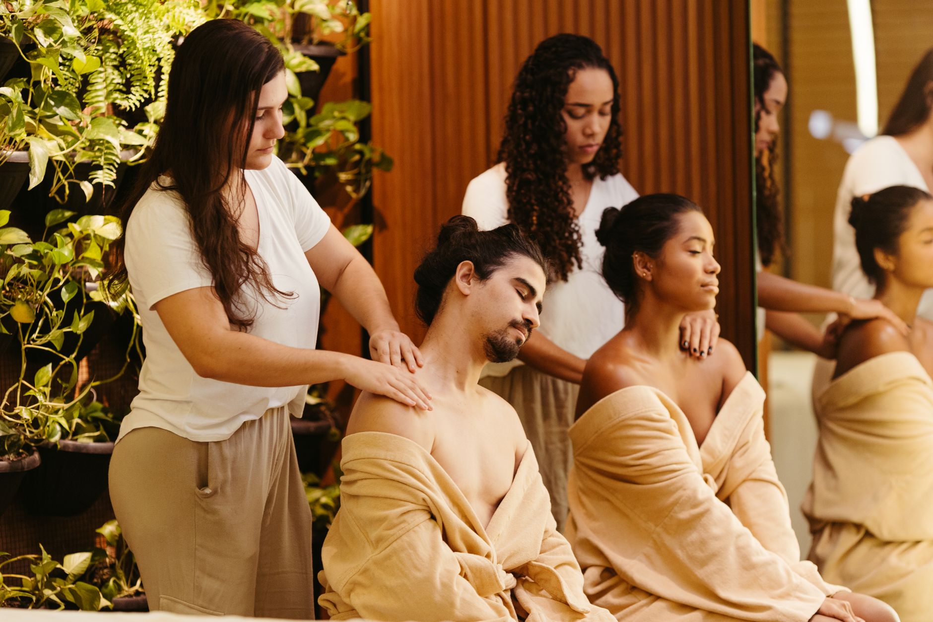 Wellbeing and holistic therapy — Two clients enjoy a relaxing massage from professional therapists in a spa setting, promoting wellness and relaxation.