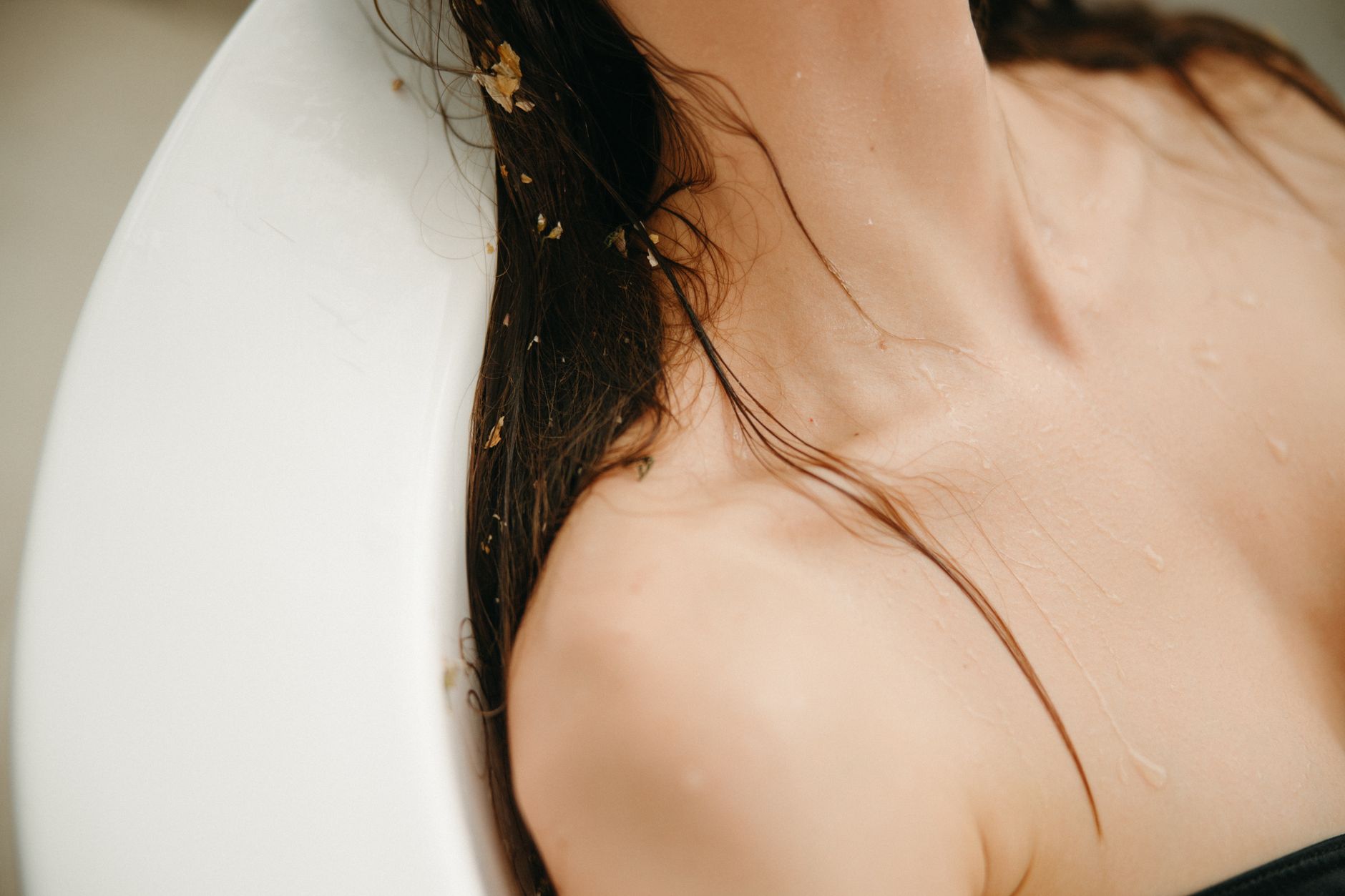 Wet spa and bathing experiences — Close-up of a woman relaxing with wet hair, emphasizing skincare and wellness.