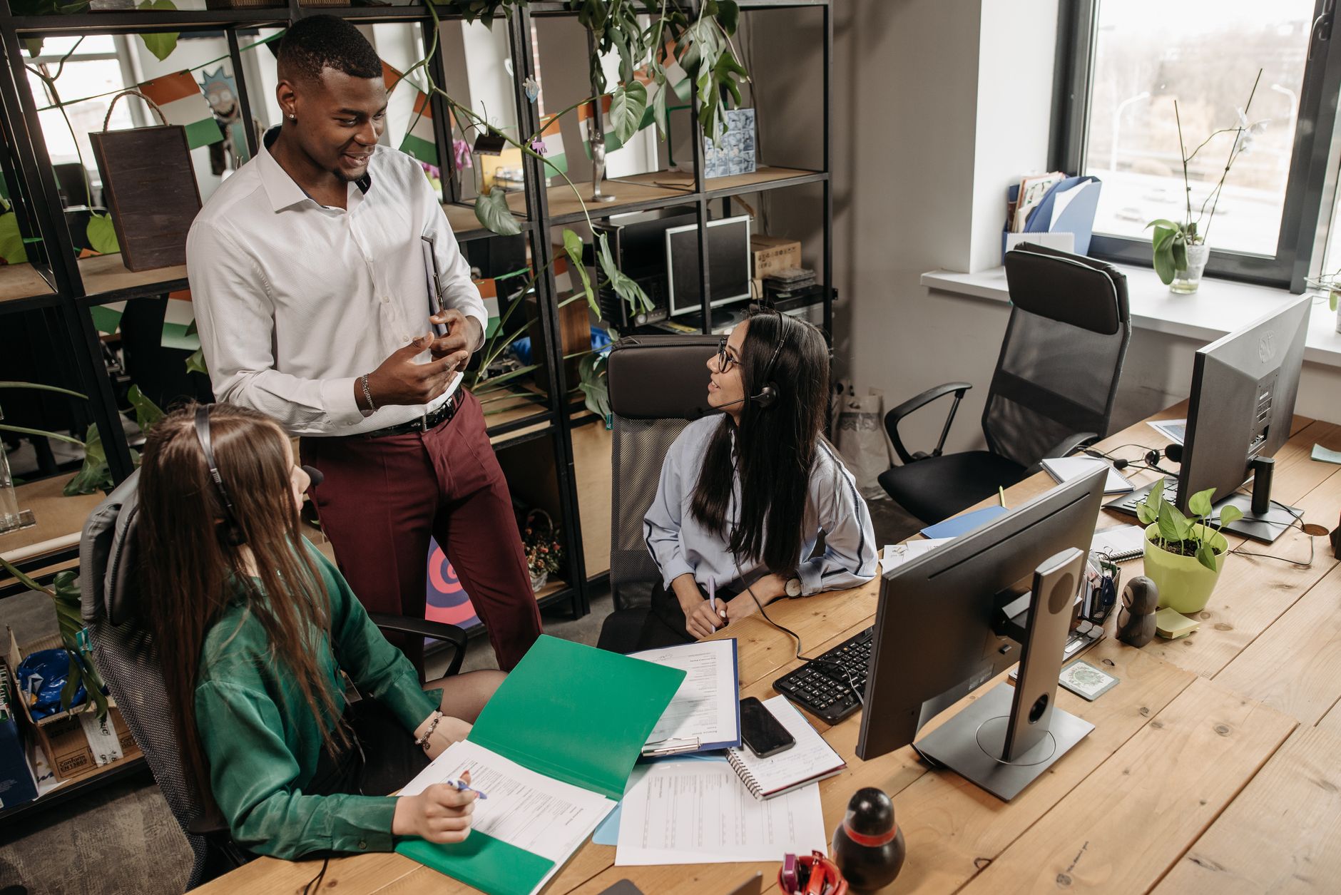 Advise on products and services — A team of diverse workers collaborating in a modern office setting.