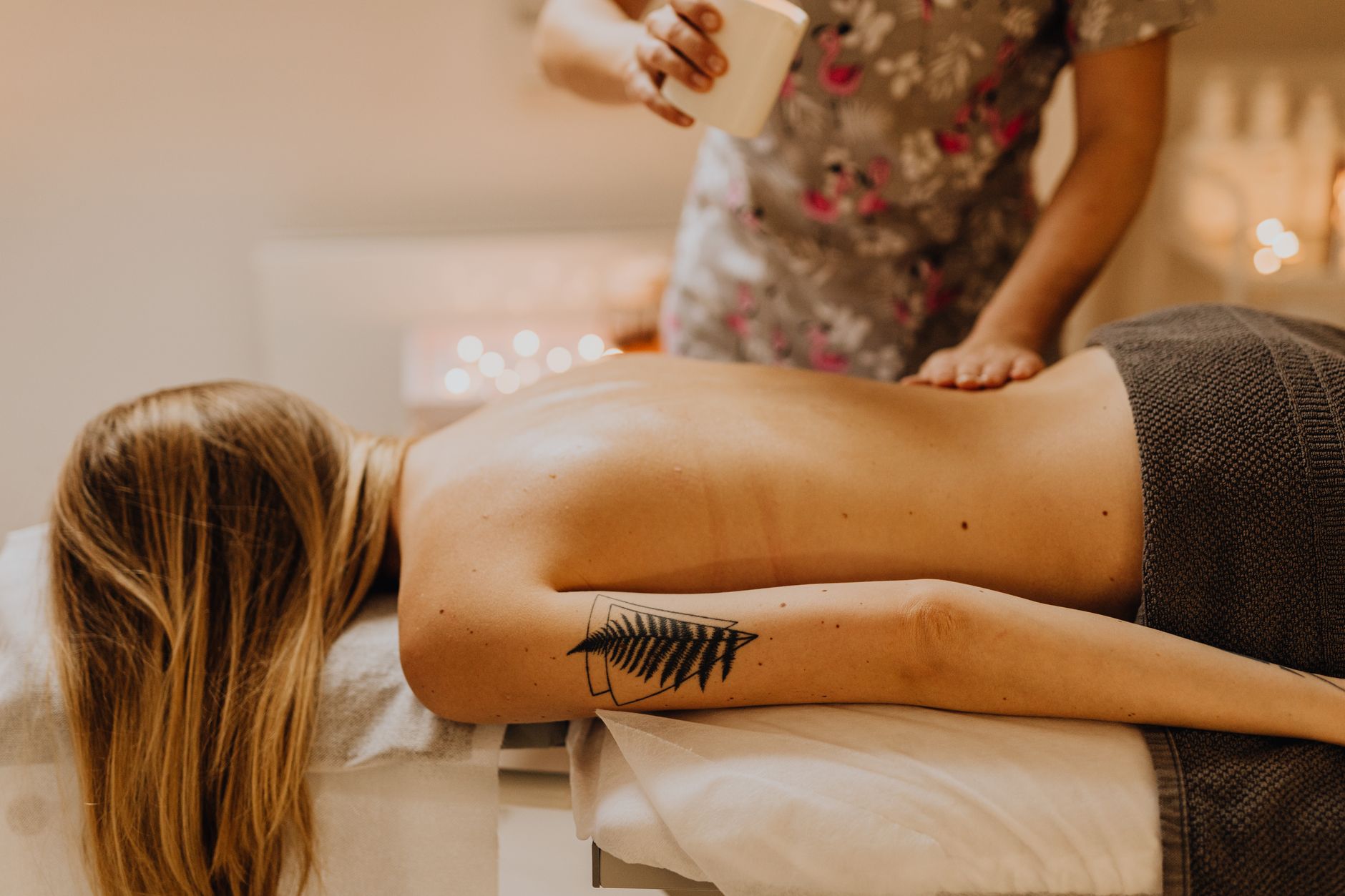 Wellbeing and holistic therapy — A serene spa massage capturing relaxation and therapy with a professional masseuse.