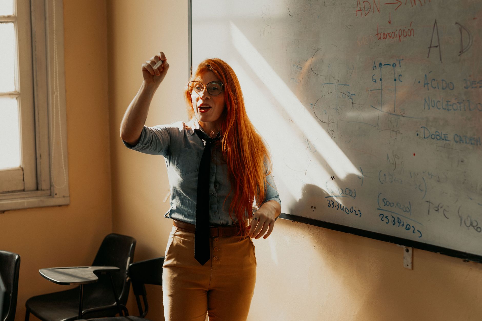 Massage using advanced techniques — A teacher explaining a concept at a whiteboard. bright classroom setting in buenos aires, argentina.